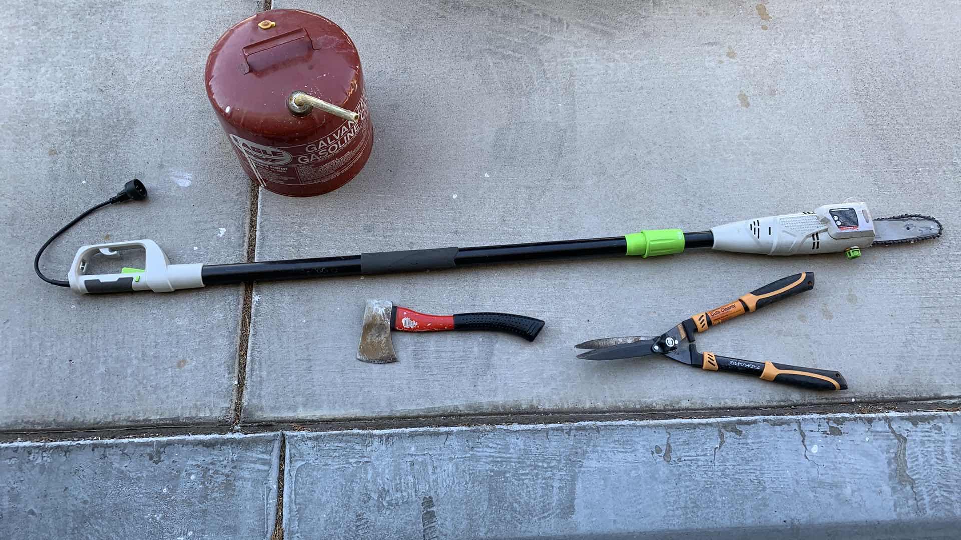 Photo 1 of ASSORTED LAWN AND GARDEN TOOLS. GAS CAN, SHEERS AND ELECTRIC POLE SAW.