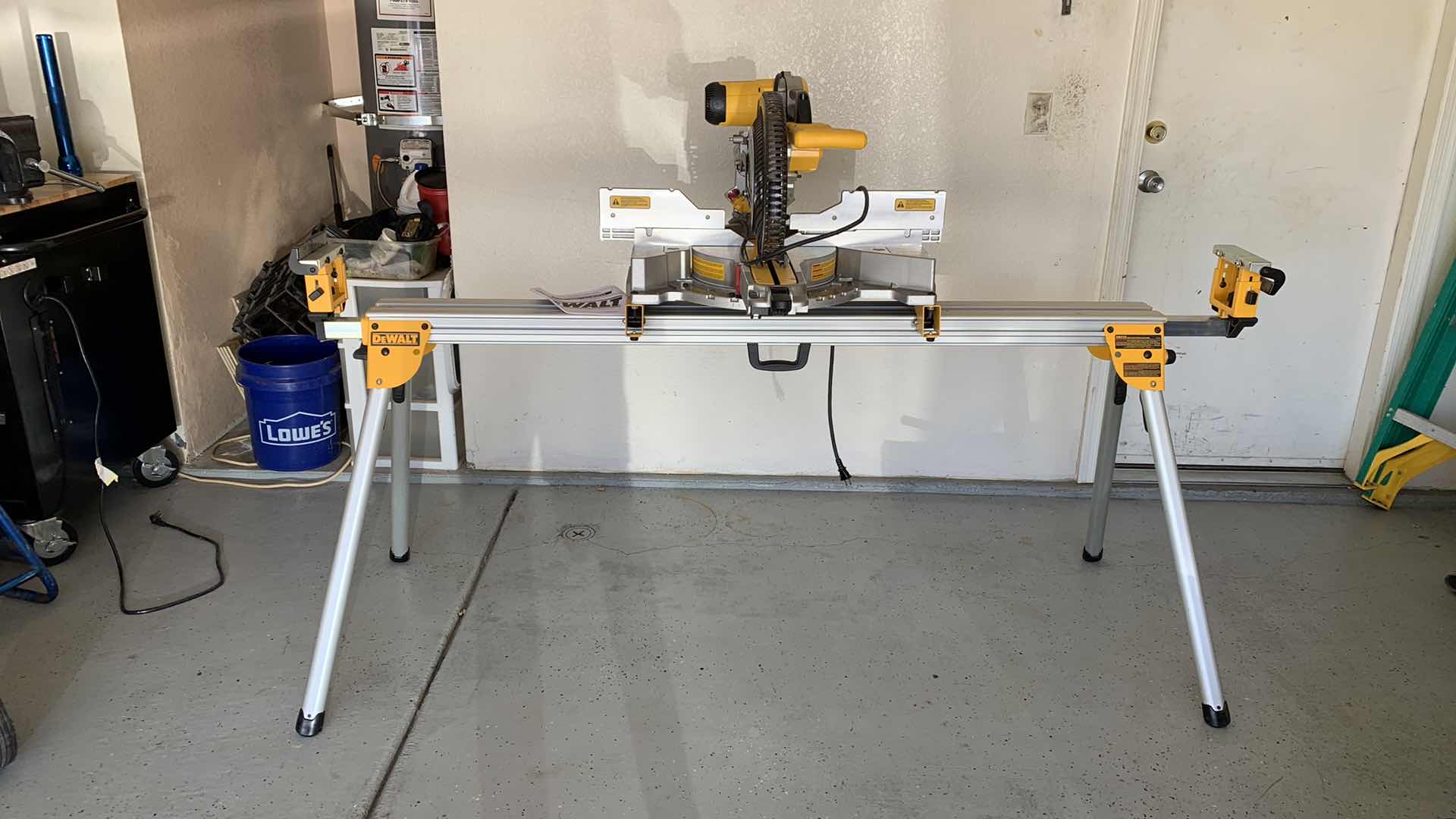 Photo 1 of DEWALT DWS779 12” DOUBLE BEVEL SLIDING COMPOUND MITER SAW AND A DWX723 HEAVY DUTY MITER SAW STAND