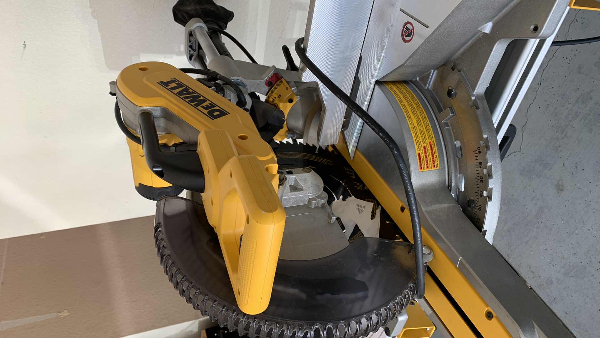 Photo 2 of DEWALT DWS779 12” DOUBLE BEVEL SLIDING COMPOUND MITER SAW AND A DWX723 HEAVY DUTY MITER SAW STAND