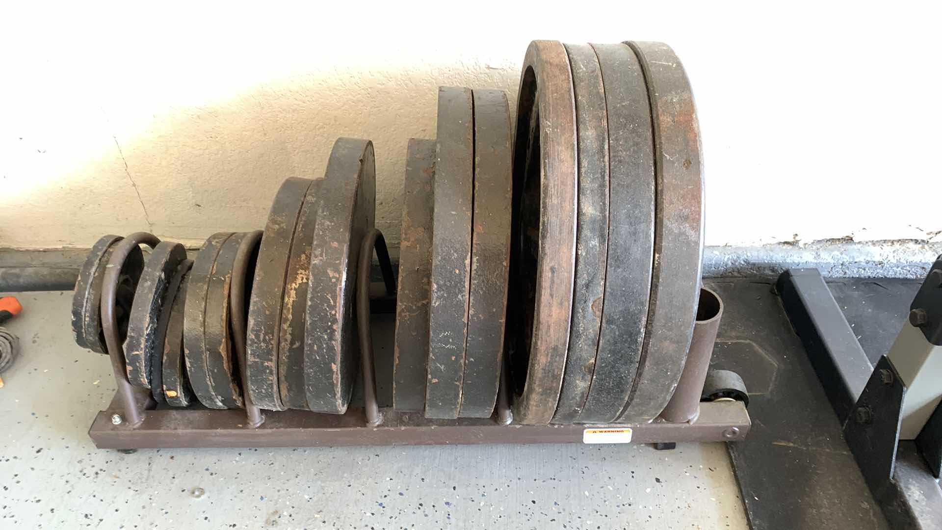 Photo 1 of EXERCISE EQUIPTMENT-OLYMPIC WEIGHT PLATES SET WITH RACK WITH WHEELS