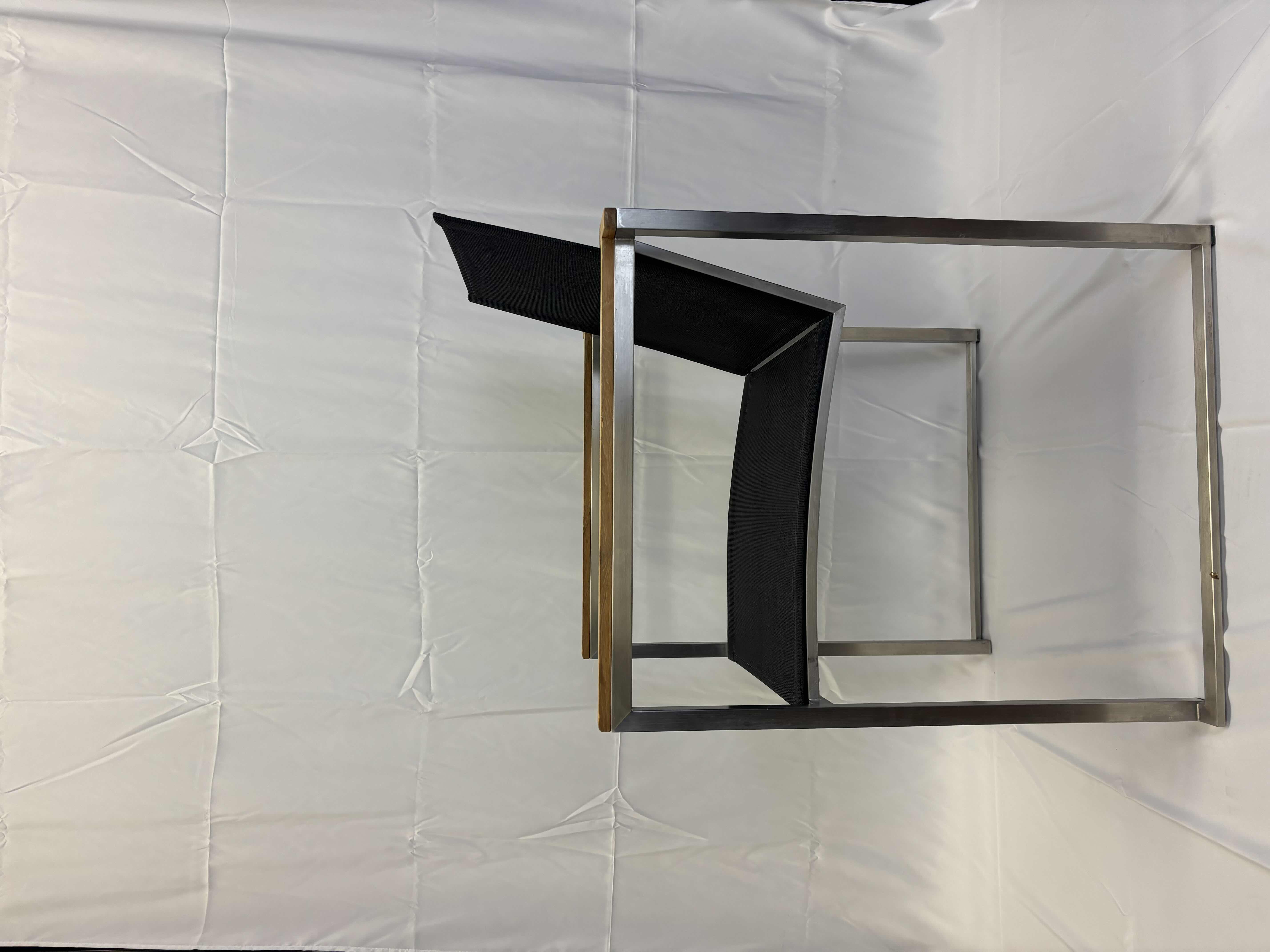 Photo 1 of VILLAGE CASA BLACK TEXTILE SLING W STAINLESS STEEL FRAME & WOOD ACCENT ARM CHAIR