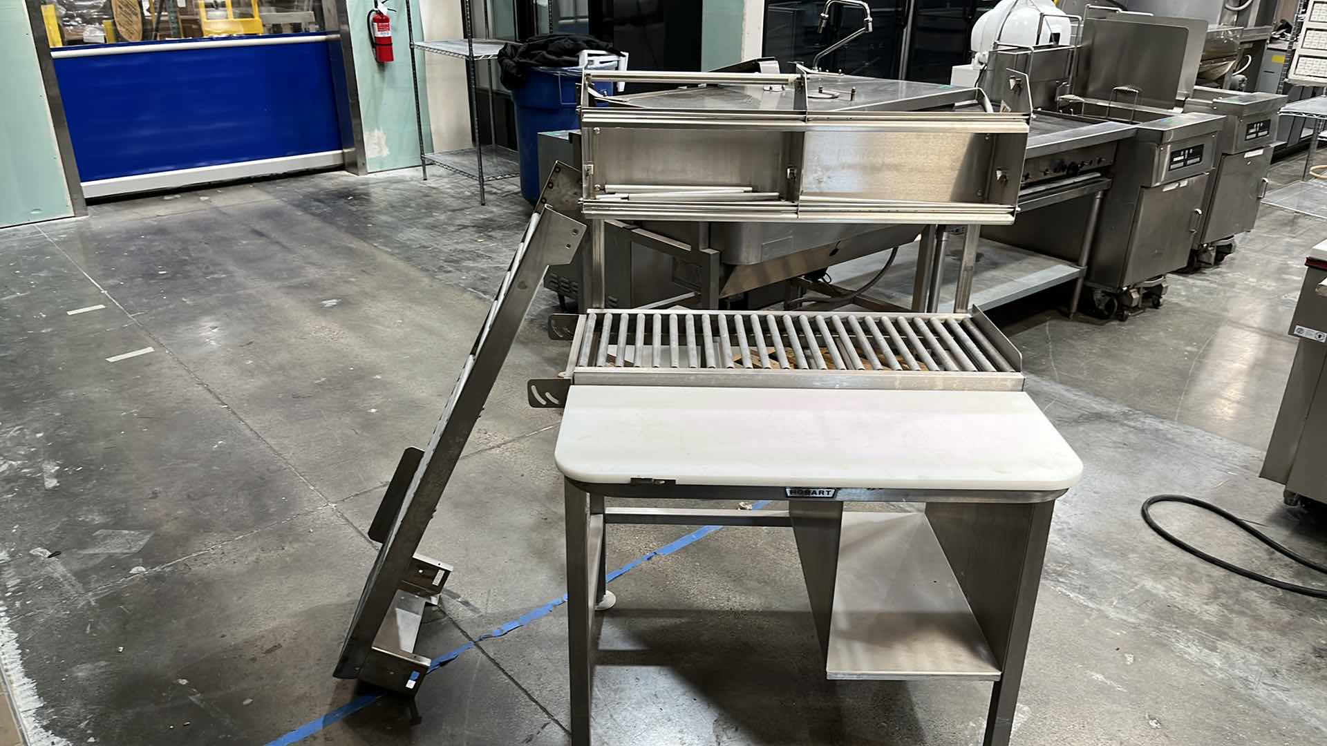 Photo 43 of HOBART COMMERCIAL DIGITAL DELI WRAPPING MACHINE W LABEL PRINTER MODEL UWS (HARDWIRED),  HEAT SEAL ENERGY SMART WRAPPER STATION W QUANTUM LABEL PRINTER (2),
HOBART ROLLER/DISCHARGE TABLE (MODEL HRT5-3)