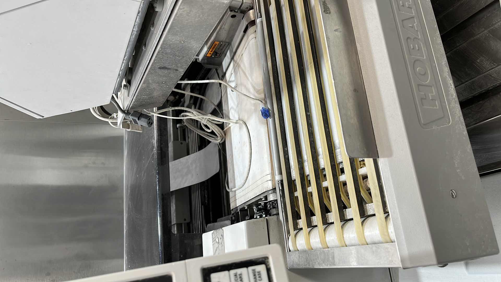 Photo 7 of HOBART COMMERCIAL DIGITAL DELI WRAPPING MACHINE W LABEL PRINTER MODEL UWS (HARDWIRED),  HEAT SEAL ENERGY SMART WRAPPER STATION W QUANTUM LABEL PRINTER (2),
HOBART ROLLER/DISCHARGE TABLE (MODEL HRT5-3)