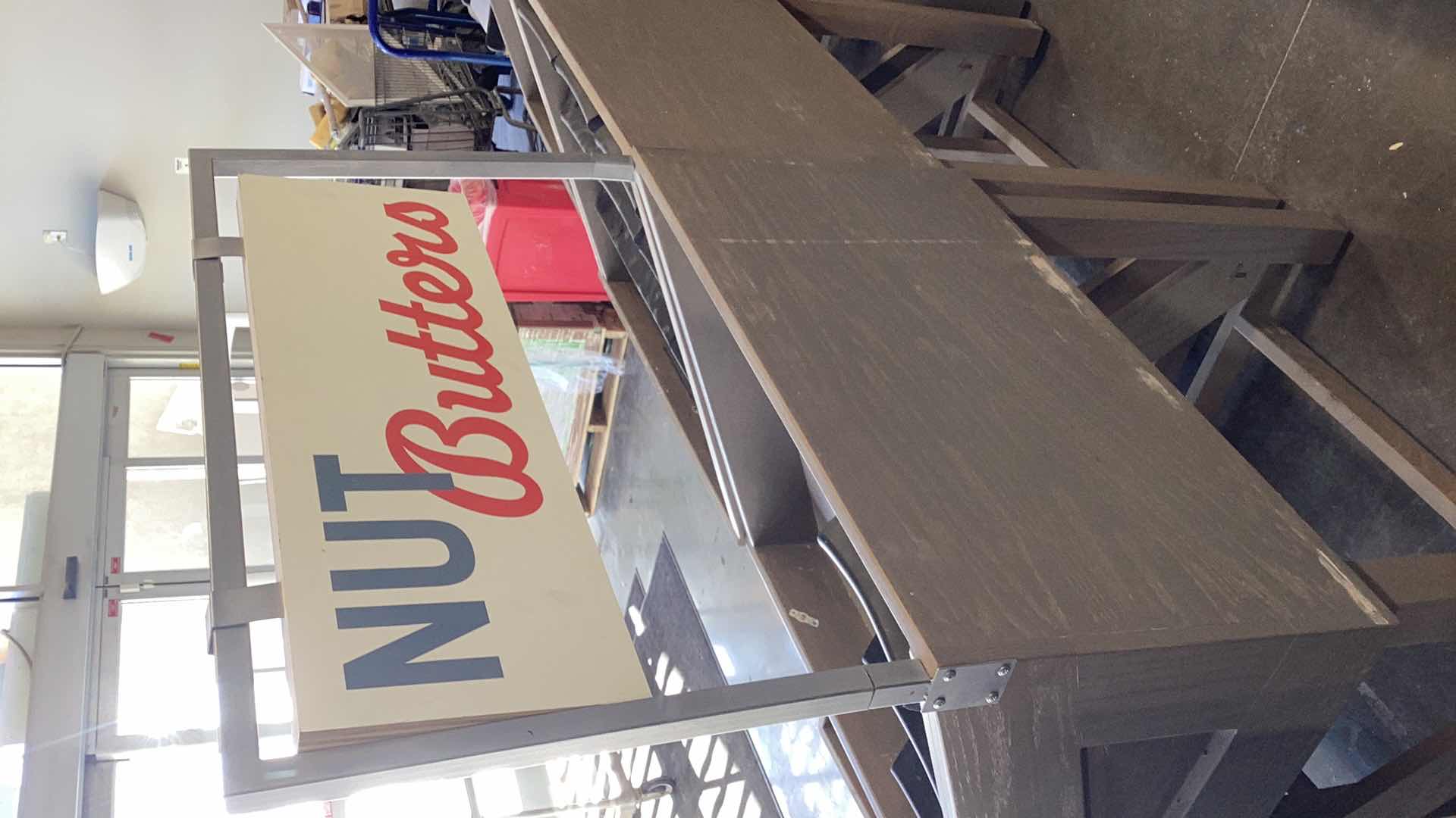 Photo 1 of TWO PIECE WOODEN ANGLED NUT BUTTERS DISPLAY STAND WITH ONE STACKER AND SIGN 36” X 28” H 37”