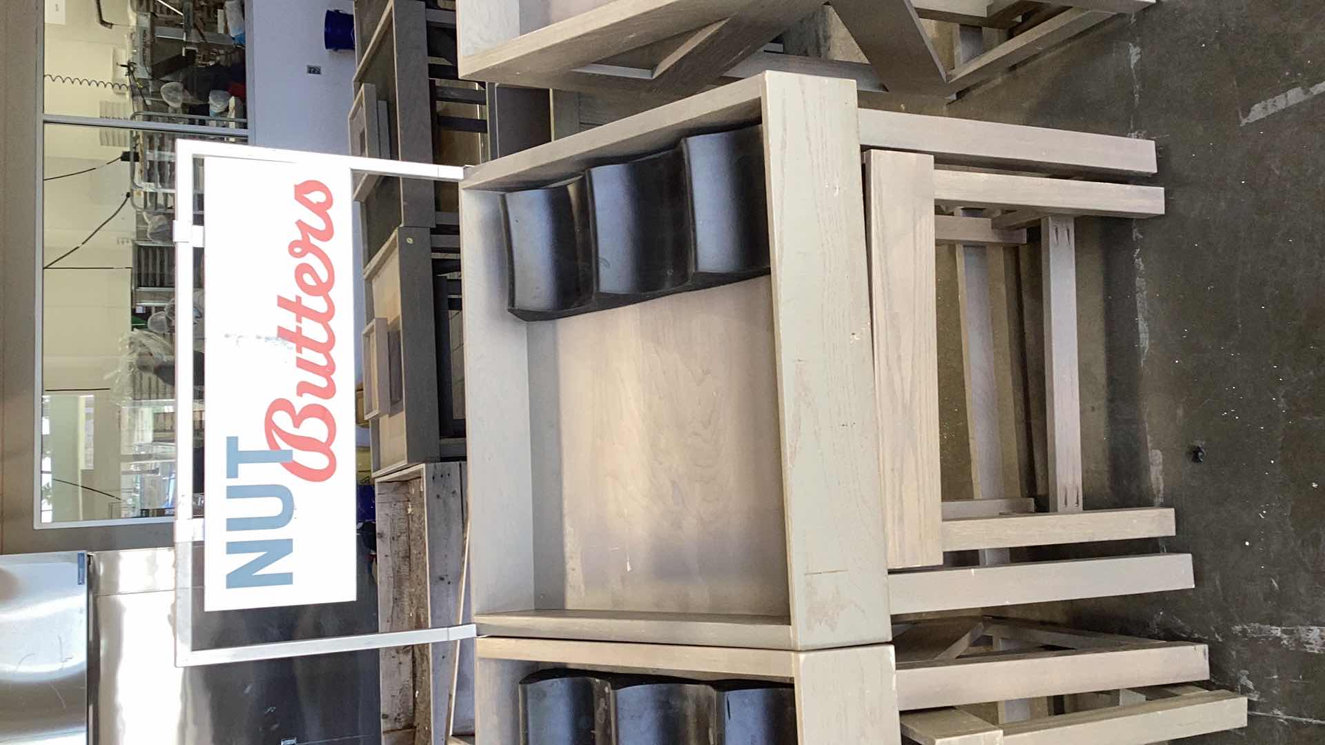 Photo 1 of TWO PIECE WOODEN ANGLED NUT BUTTERS DISPLAY STAND WITH ONE STACKER AND SIGN 36” X 28” H 37”