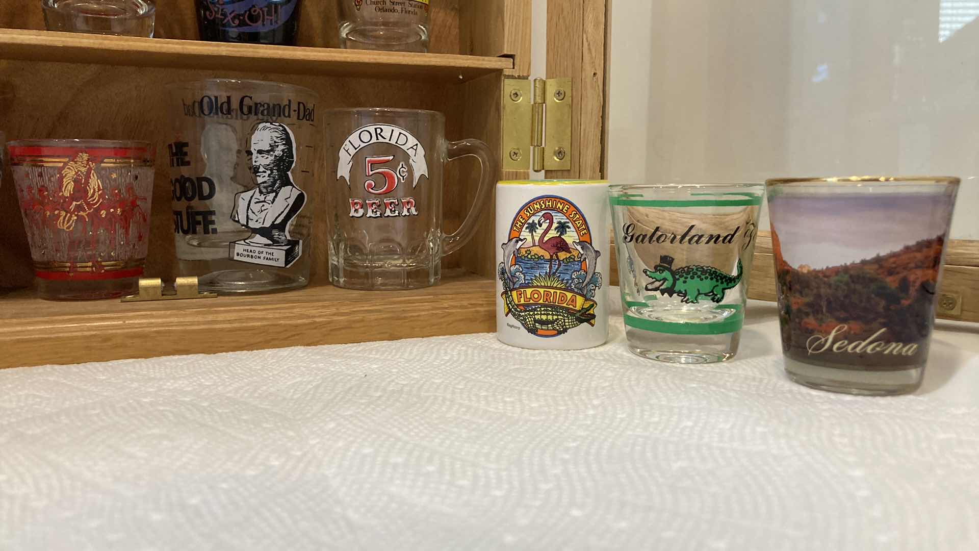 Photo 1 of SHOT GLASS COLLECTION W GLASS DOOR WOOD CABINET