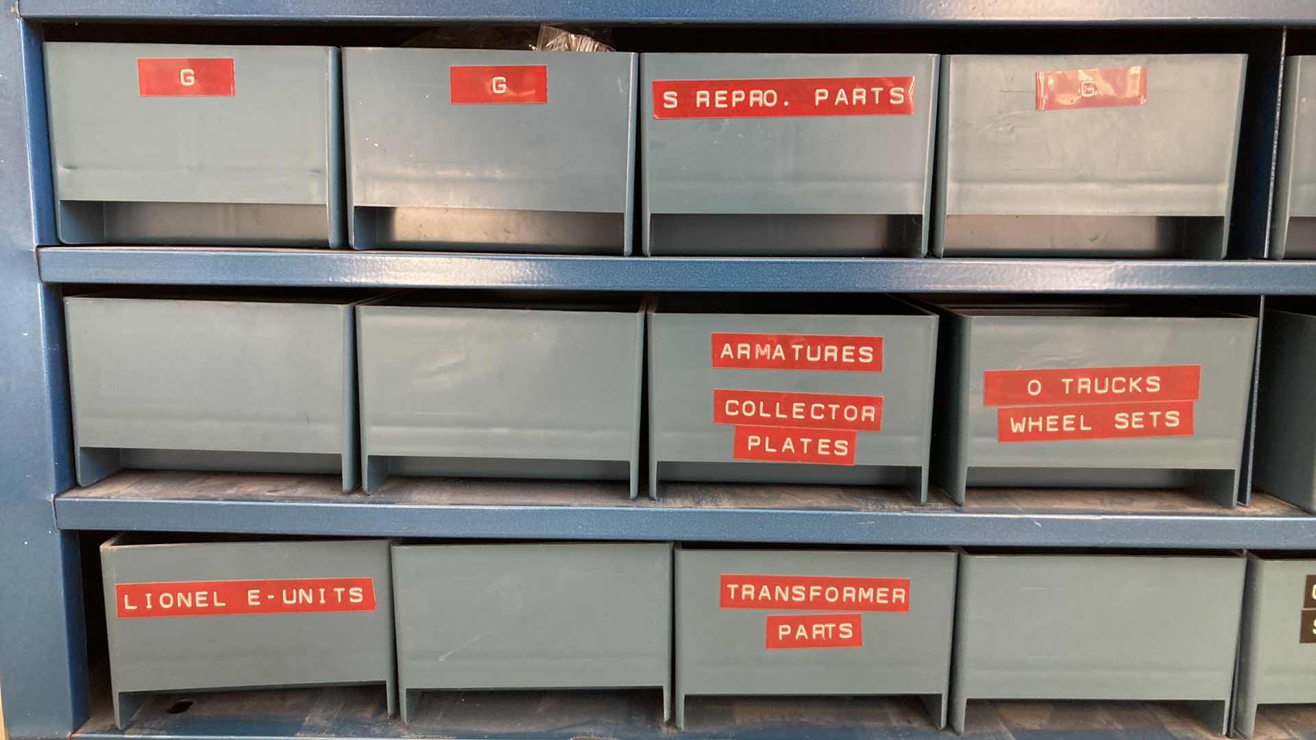 Photo 1 of BOWMAN 24 DRAWER STEEL STORAGE CABINET W MODEL TRAIN PARTS AS LABELED 35” X 12” H10.75”