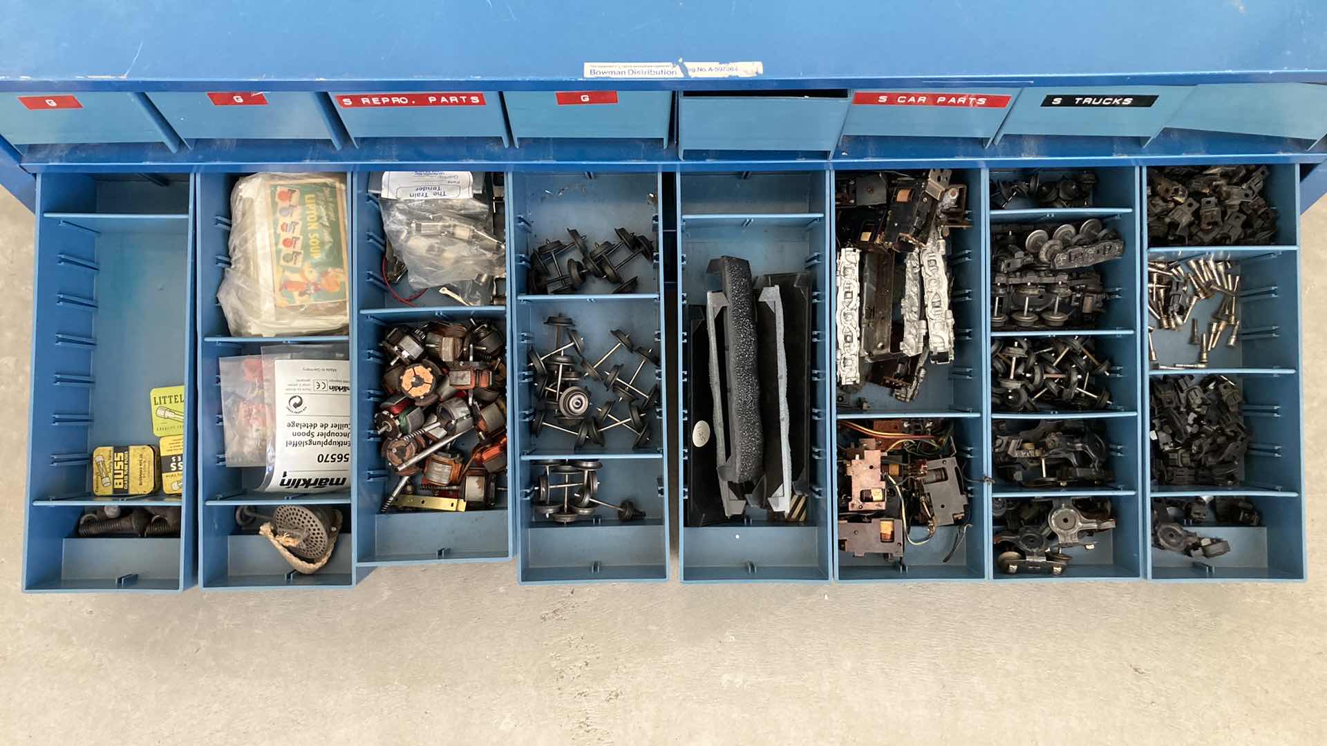 Photo 1 of BOWMAN 24 DRAWER STEEL STORAGE CABINET W MODEL TRAIN PARTS AS LABELED 35” X 12” H10.75”