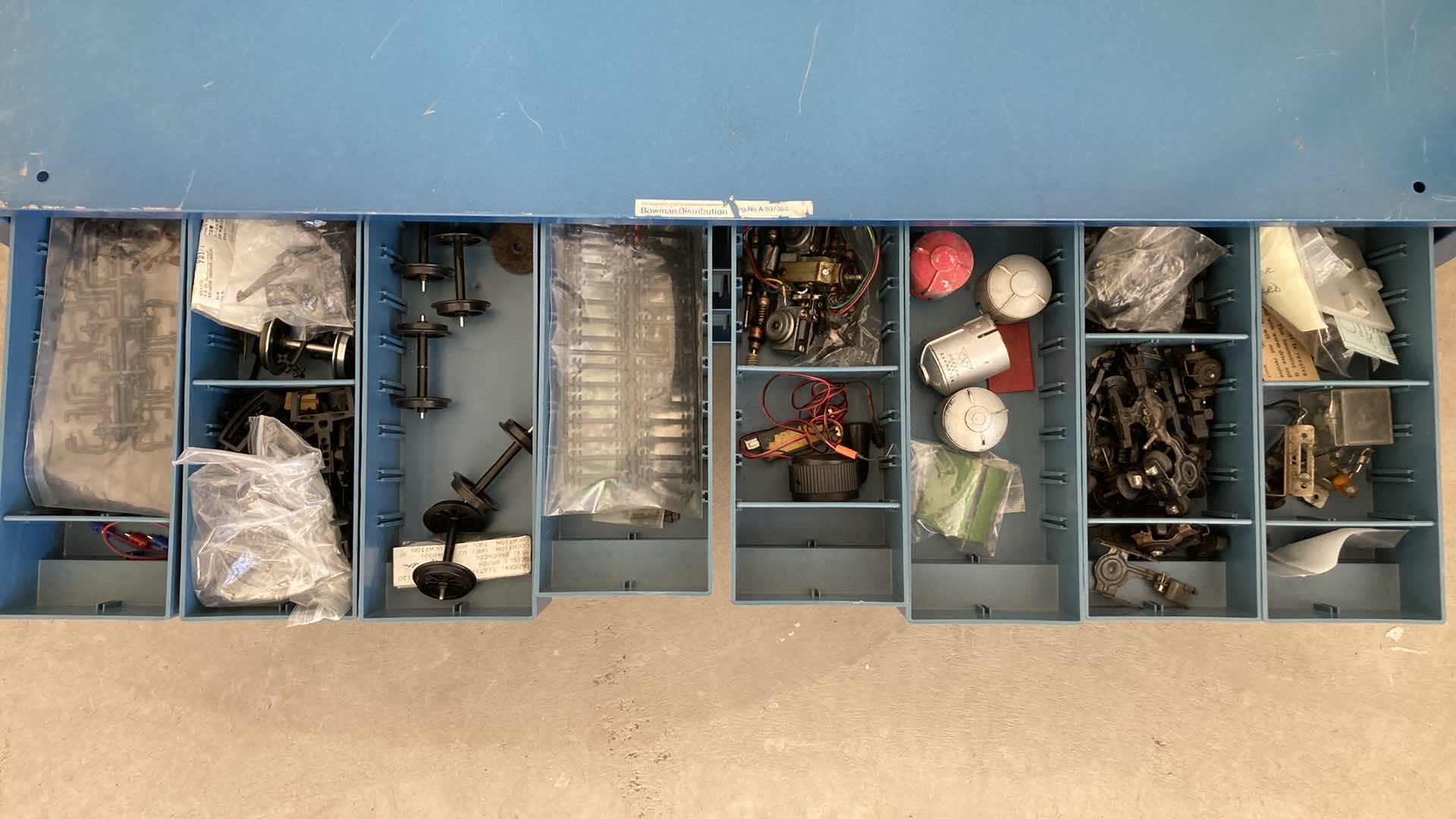 Photo 1 of BOWMAN 24 DRAWER STEEL STORAGE CABINET W MODEL TRAIN PARTS AS LABELED 35” X 12” H10.75”