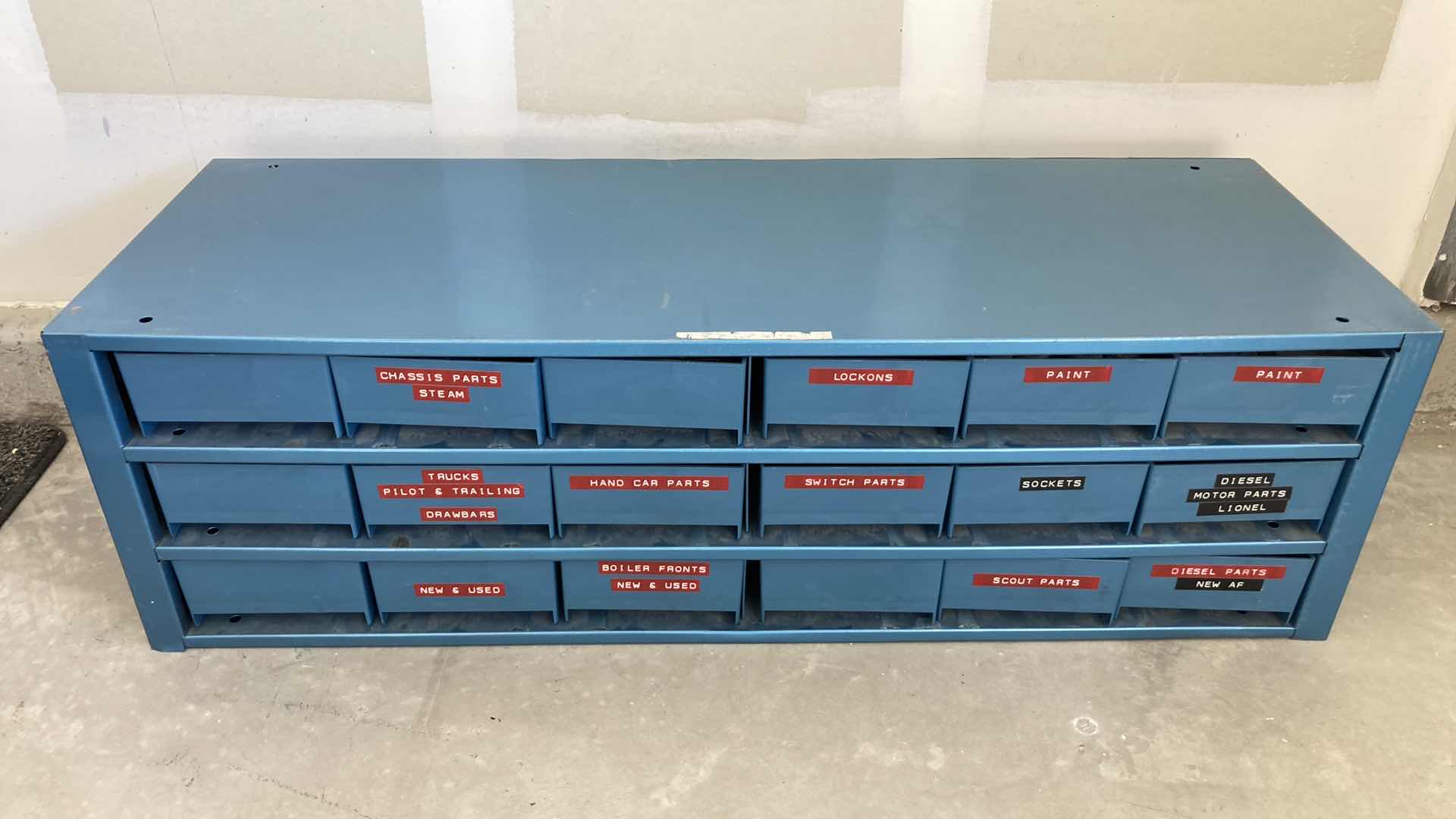 Photo 1 of BOWMAN 18 DRAWER STEEL STORAGE CABINET W MODEL TRAIN PARTS AS LABELED 35” X 12” H10.75”