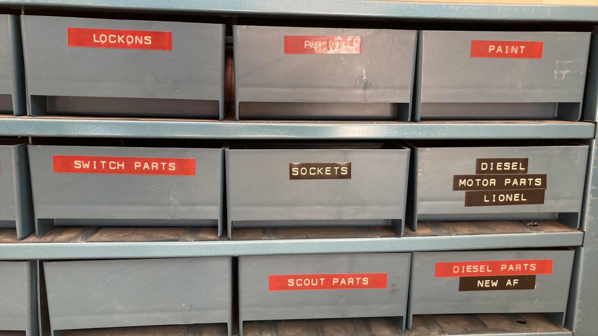 Photo 1 of BOWMAN 18 DRAWER STEEL STORAGE CABINET W MODEL TRAIN PARTS AS LABELED 35” X 12” H10.75”