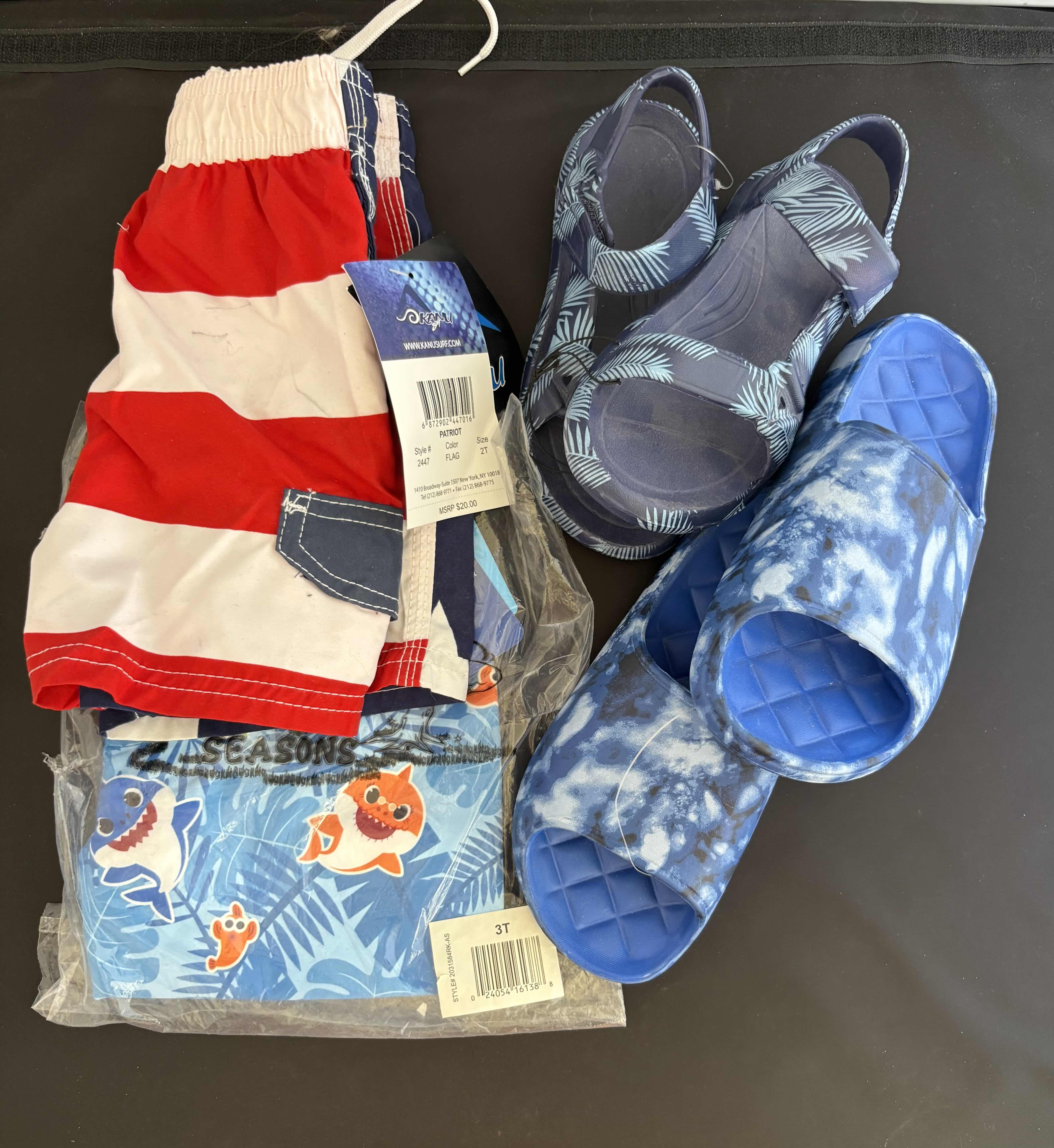Photo 1 of BRAND NEW - LITTLE BOYS SWIM TRUNKS AND WATER SHOES, 2T PATRIOTIC SWIM TRUNKS, 3T BABY SHARK SWIM TRUNKS, SIZE 13 BLUE TIE-DYE SLIDES, SIZE 11 BLUE PALM LEAVES SANDALS