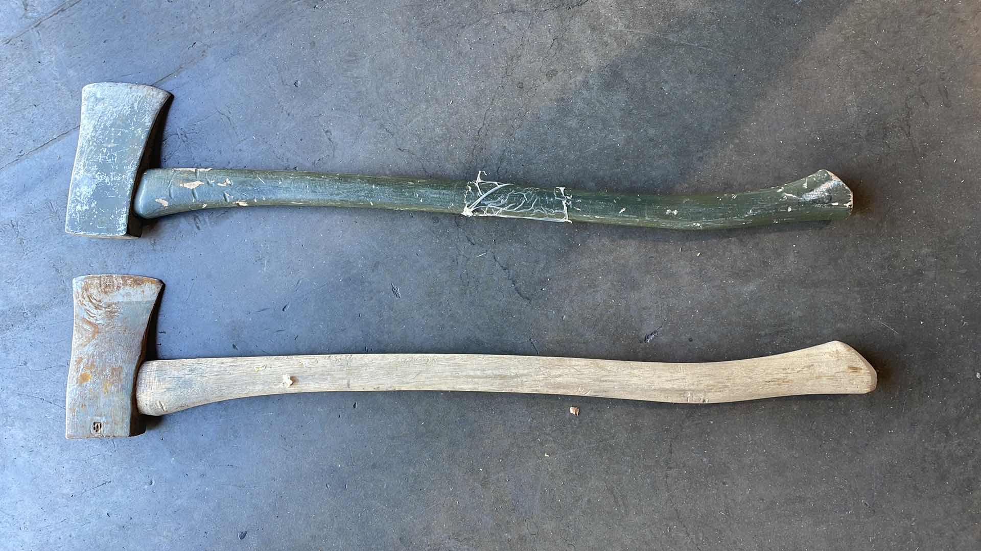 Photo 1 of 2 AXES WITH WOOD HANDLES GREEN HANDLE AXE HEAD IS A LITTLE LOOSE