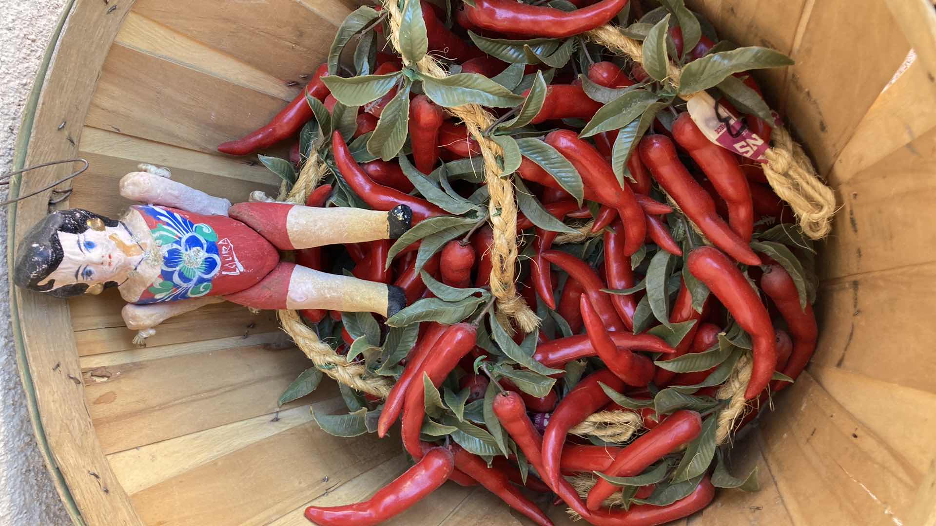 Photo 1 of WOOD BASKET 18” X 14” W PLASTIC CHILIES AND PAPIER-MACHE DOLL