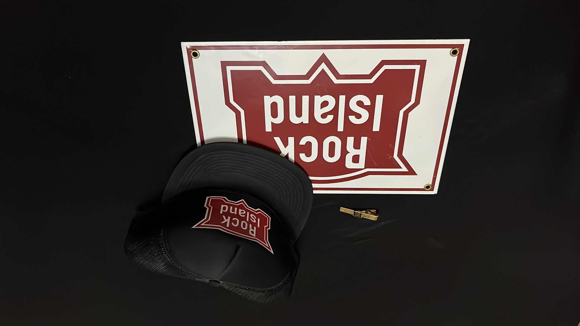 View 1 of ROCK ISLAND TRUCKER HAT, TIE PIN & METAL/TIN SIGN 12” X 8”