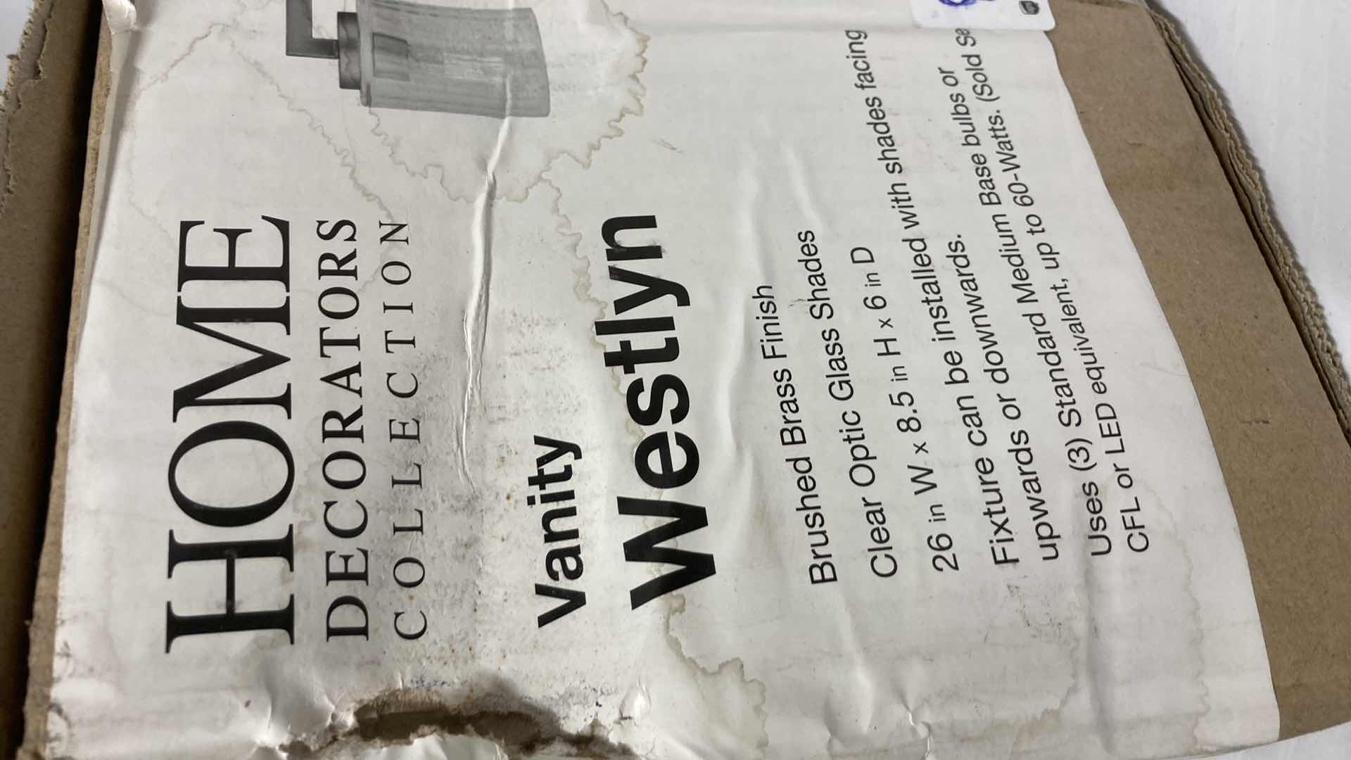 Photo 1 of NEW HOME DECORATORS WESTLYN  BRUSHED BRASS FINISH CLEAR OPTIC GLASS 3 LIGHT VANITY FIXTURE MODEL 1004341951