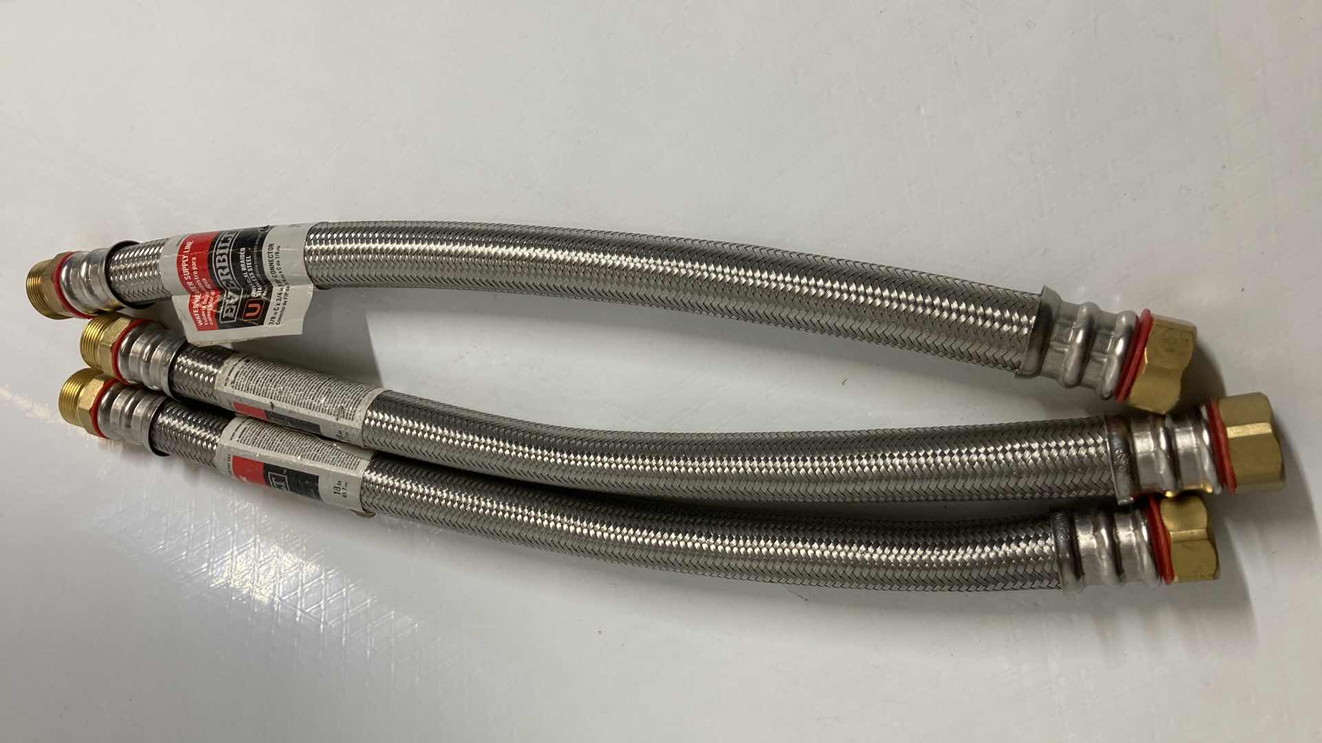 Photo 1 of NEW EVERBILT UNIVERSAL BRAIDED STAINLESS STEEL WATER HEATER SUPPLY LINE (3) 7/8” C 3/4” X 18”