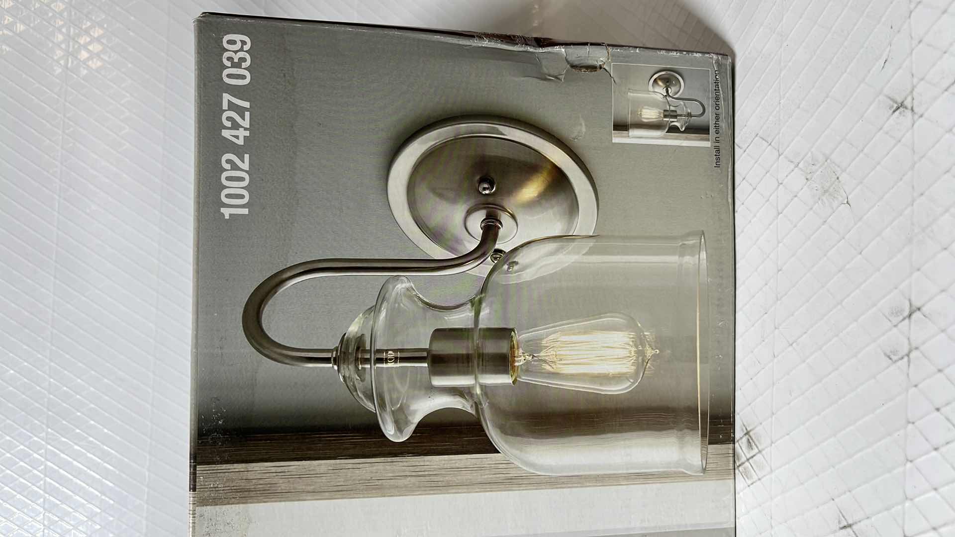 Photo 1 of HOME DECORATORS COLLECTION GARRIDAN COLLECTION SCONCE, BRUSHED NICKEL FINISH W CLEAR GLASS SHADE (1002 427 039)