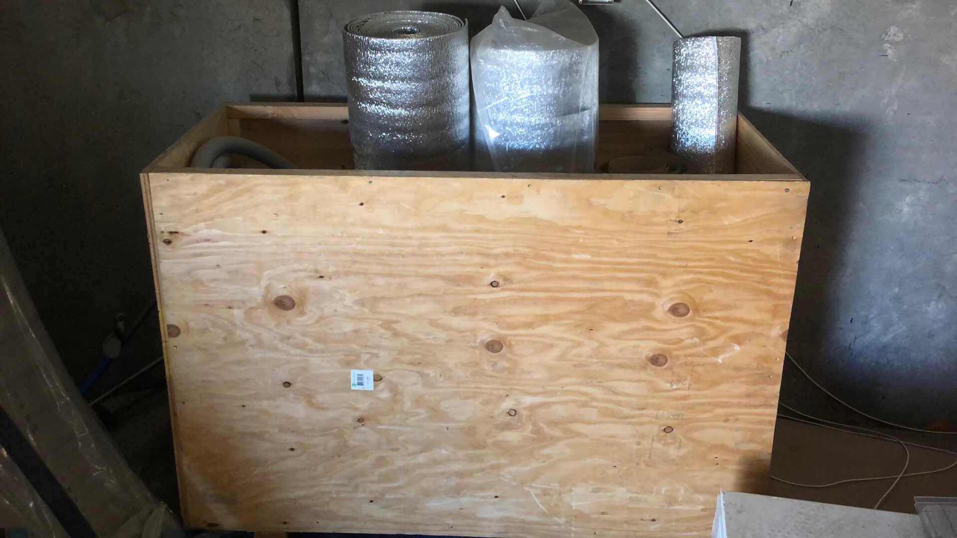 Photo 1 of ASSORTED INSULATING MATERIAL RUBBER HOSE AND LARGE PLASTIC VESSEL CRATE INCLUDED