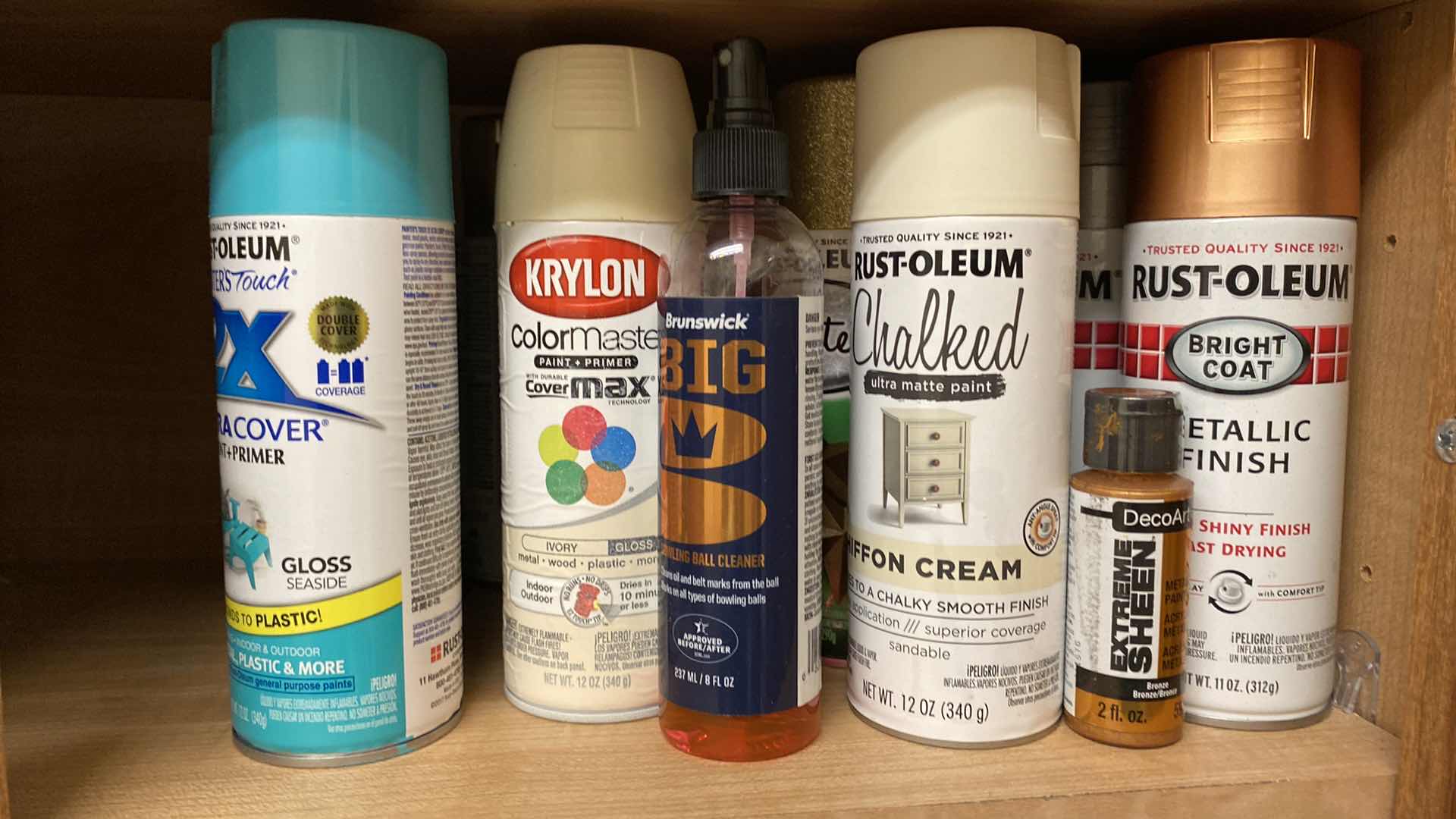 Photo 1 of CONTENTS OF CABINET SEED MAT, SPRAY PAINT AND LAUNDRY SUPPLIES