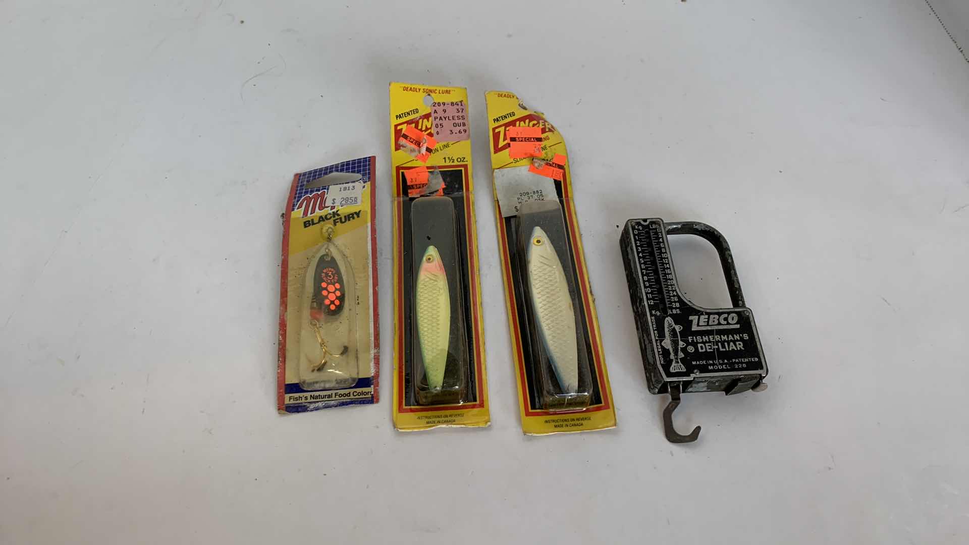 Photo 1 of VINTAGE FISHING LURES AND ZEBCO SCALE