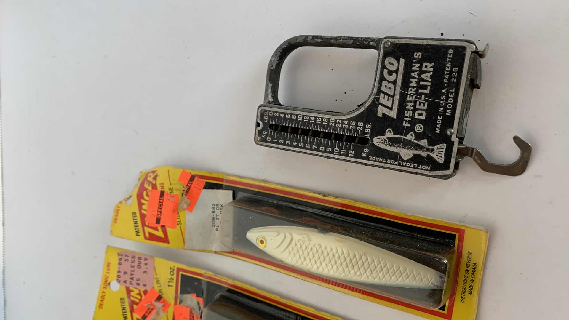 Photo 1 of VINTAGE FISHING LURES AND ZEBCO SCALE