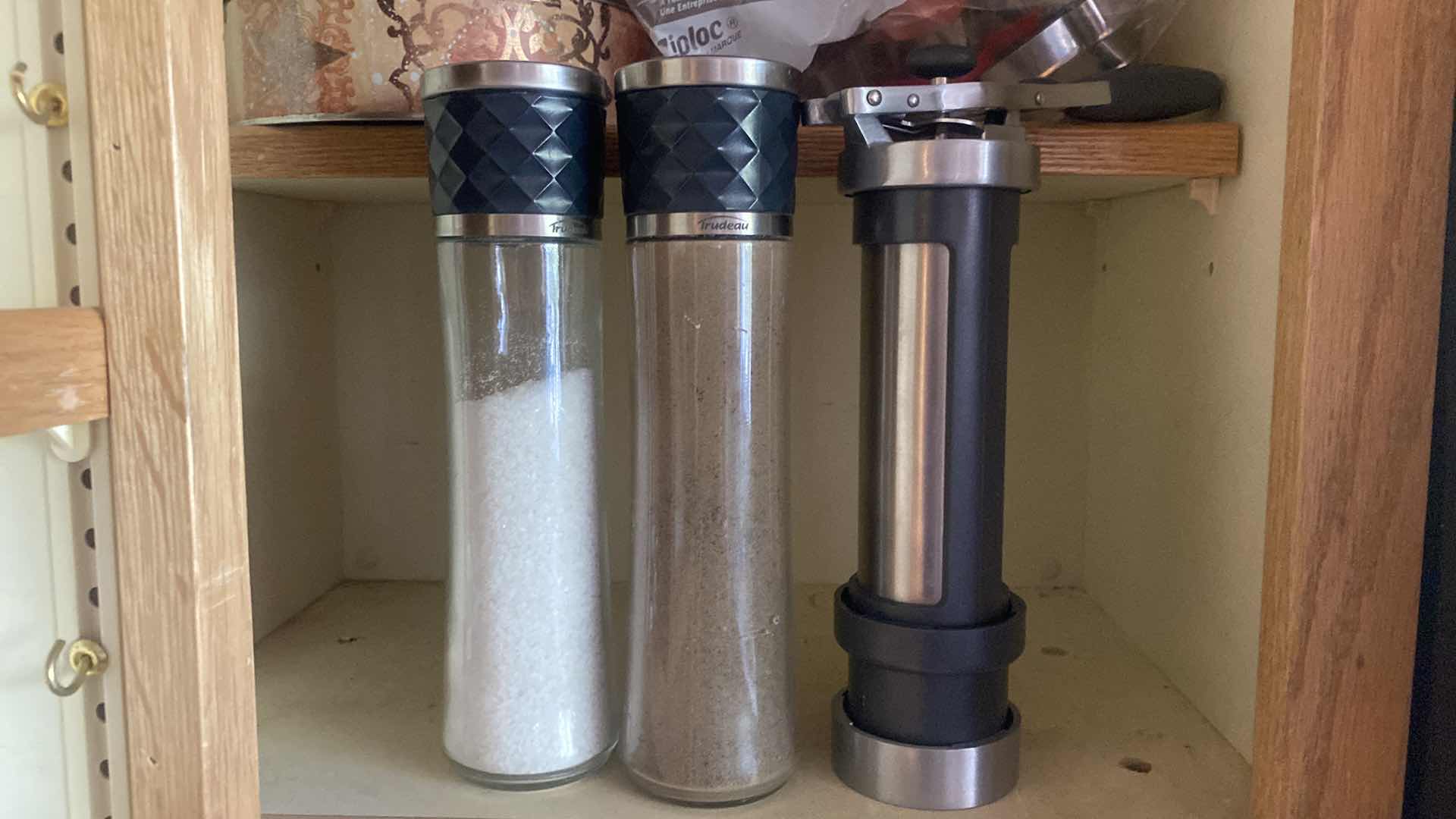 Photo 1 of CONTENTS KITCHEN CABINET - SALT & PEPPER GRINDERS, TINS & COOKIE CUTTERS