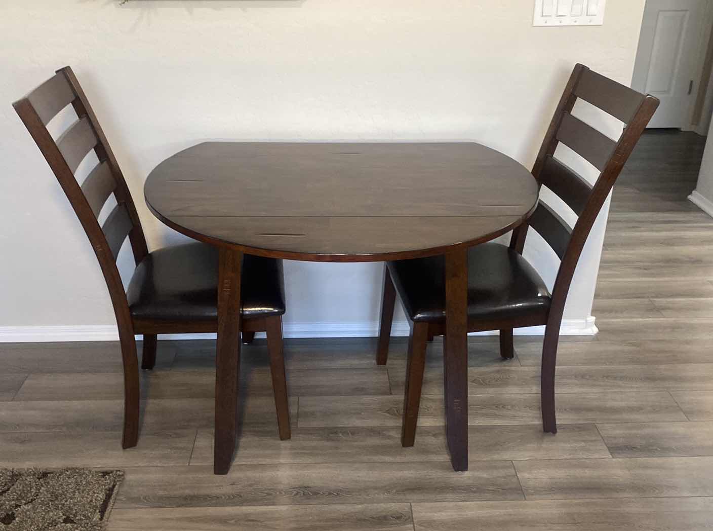 Photo 1 of DARK WOOD DINING TABLE WITHOUT SIDES EXTENDED 42“ x 24” H30“, EXTENDED 41” ROUND WITH 2 CHAIRS