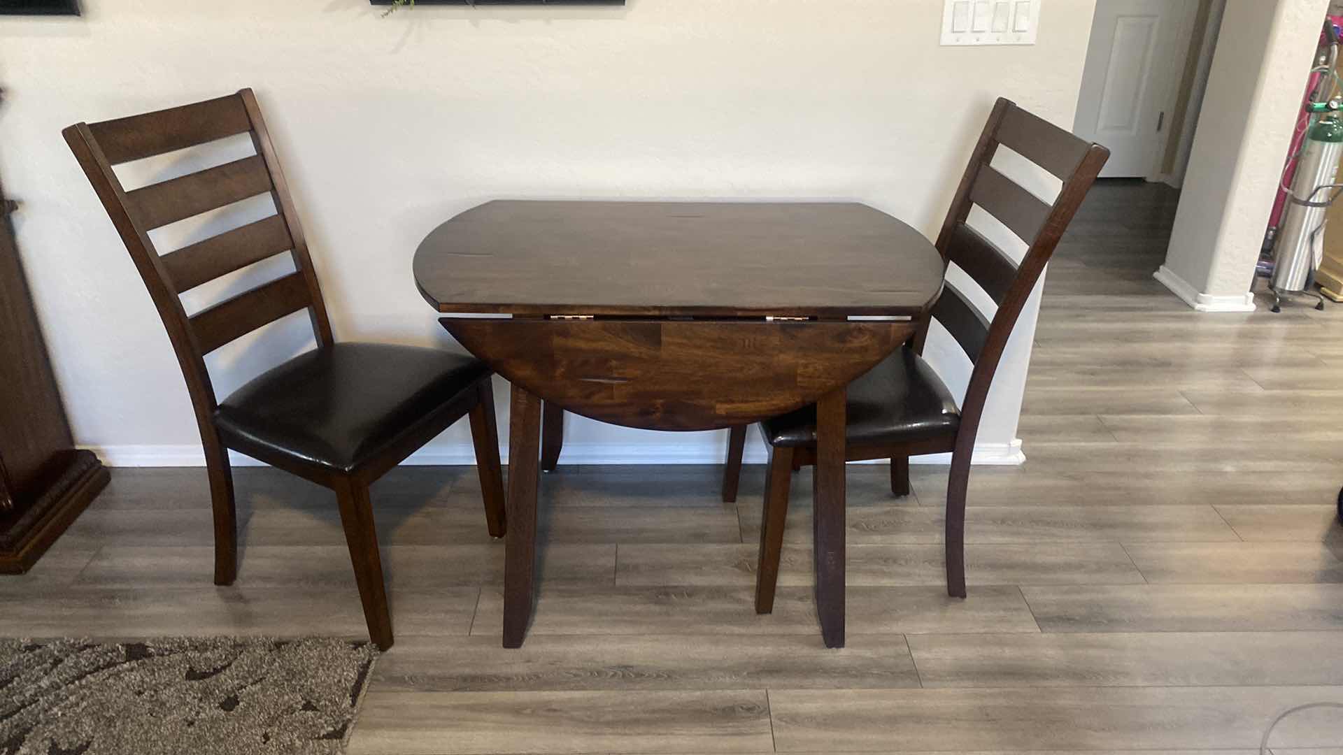 Photo 1 of DARK WOOD DINING TABLE WITHOUT SIDES EXTENDED 42“ x 24” H30“, EXTENDED 41” ROUND WITH 2 CHAIRS