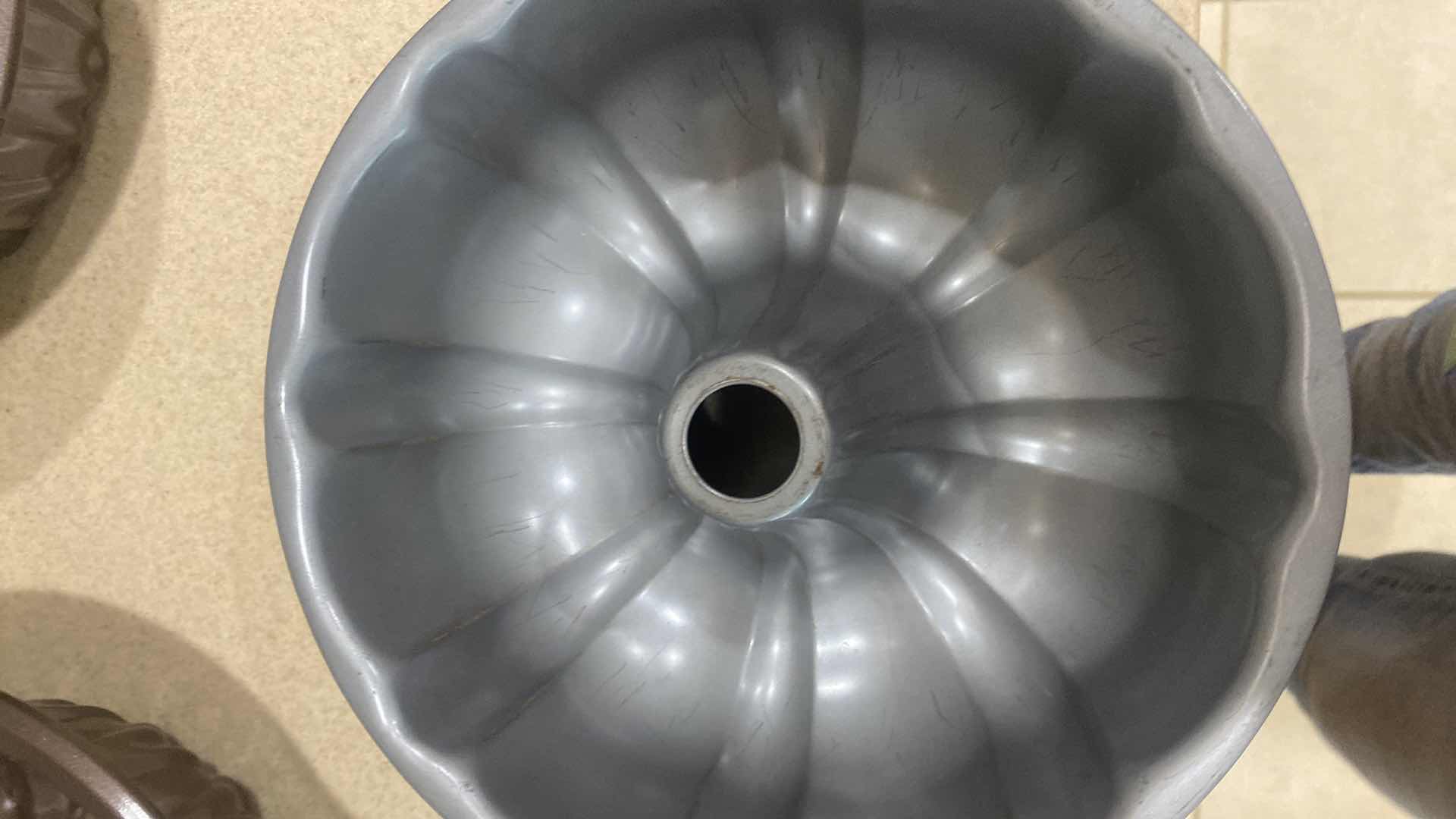 Photo 1 of CONTENTS OF KITCHEN CABINET- 3 BUNDT PANS