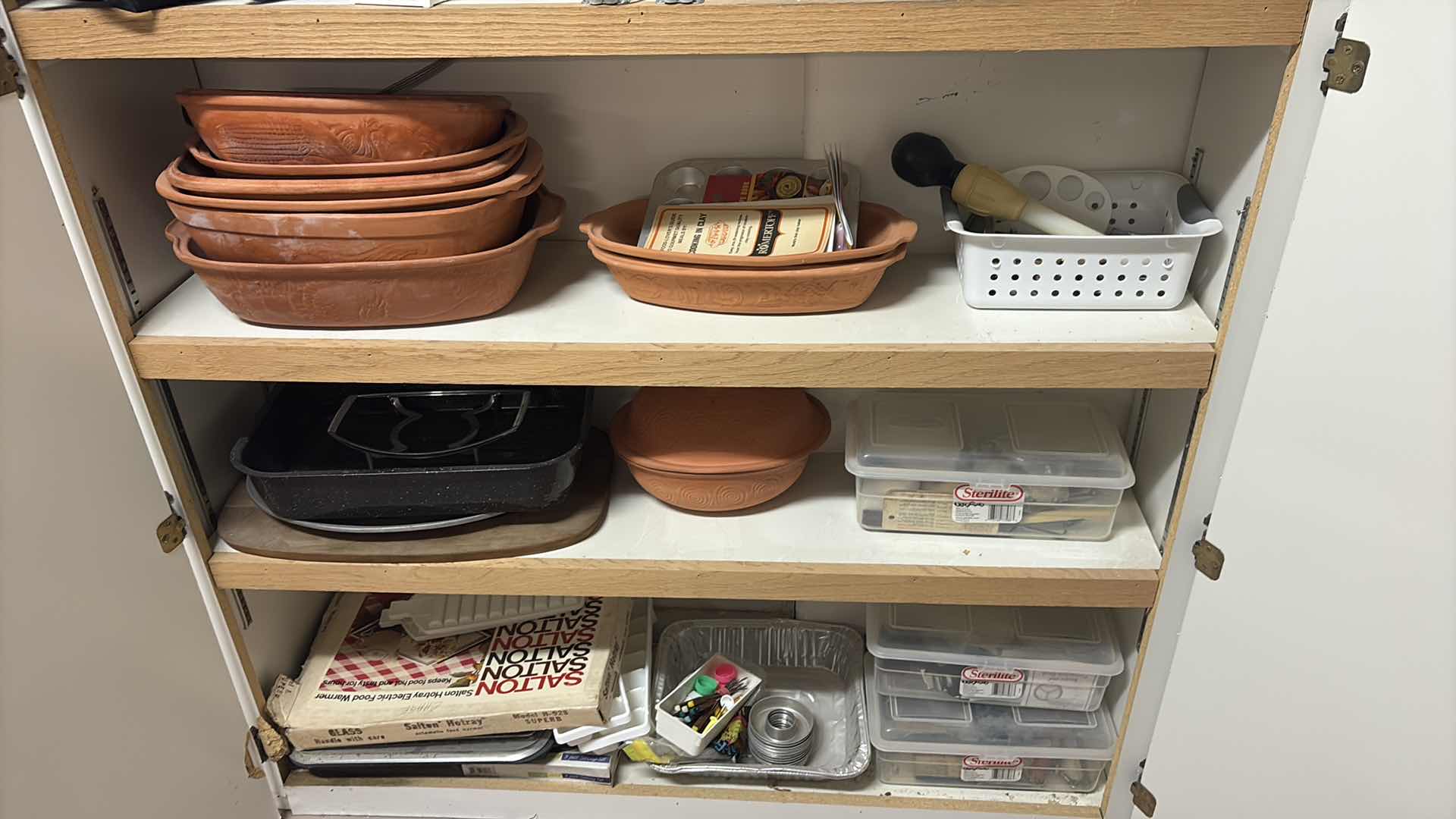 Photo 1 of CONTENTS OF CABINET- CLAY COOKING
