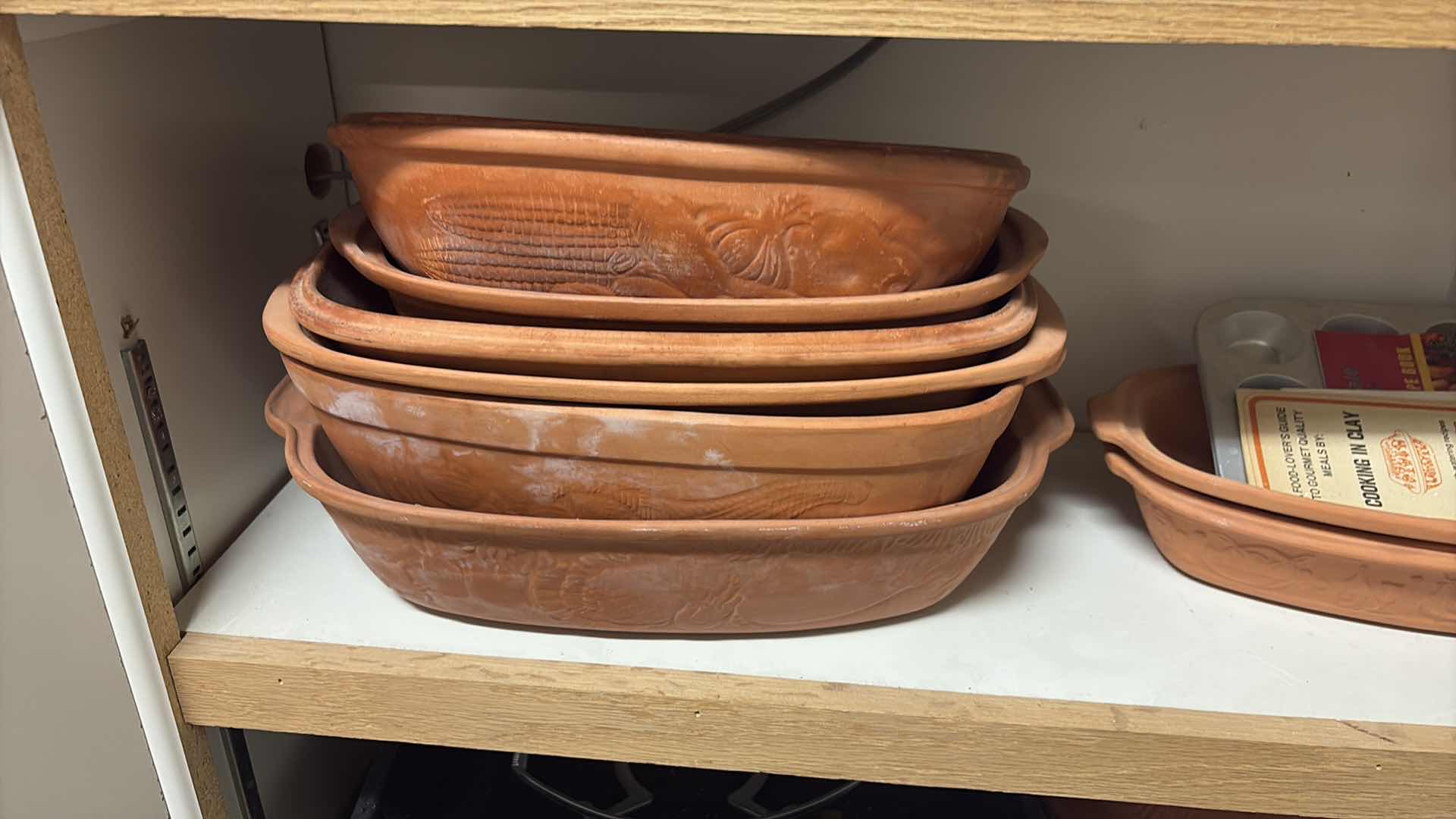 Photo 1 of CONTENTS OF CABINET- CLAY COOKING