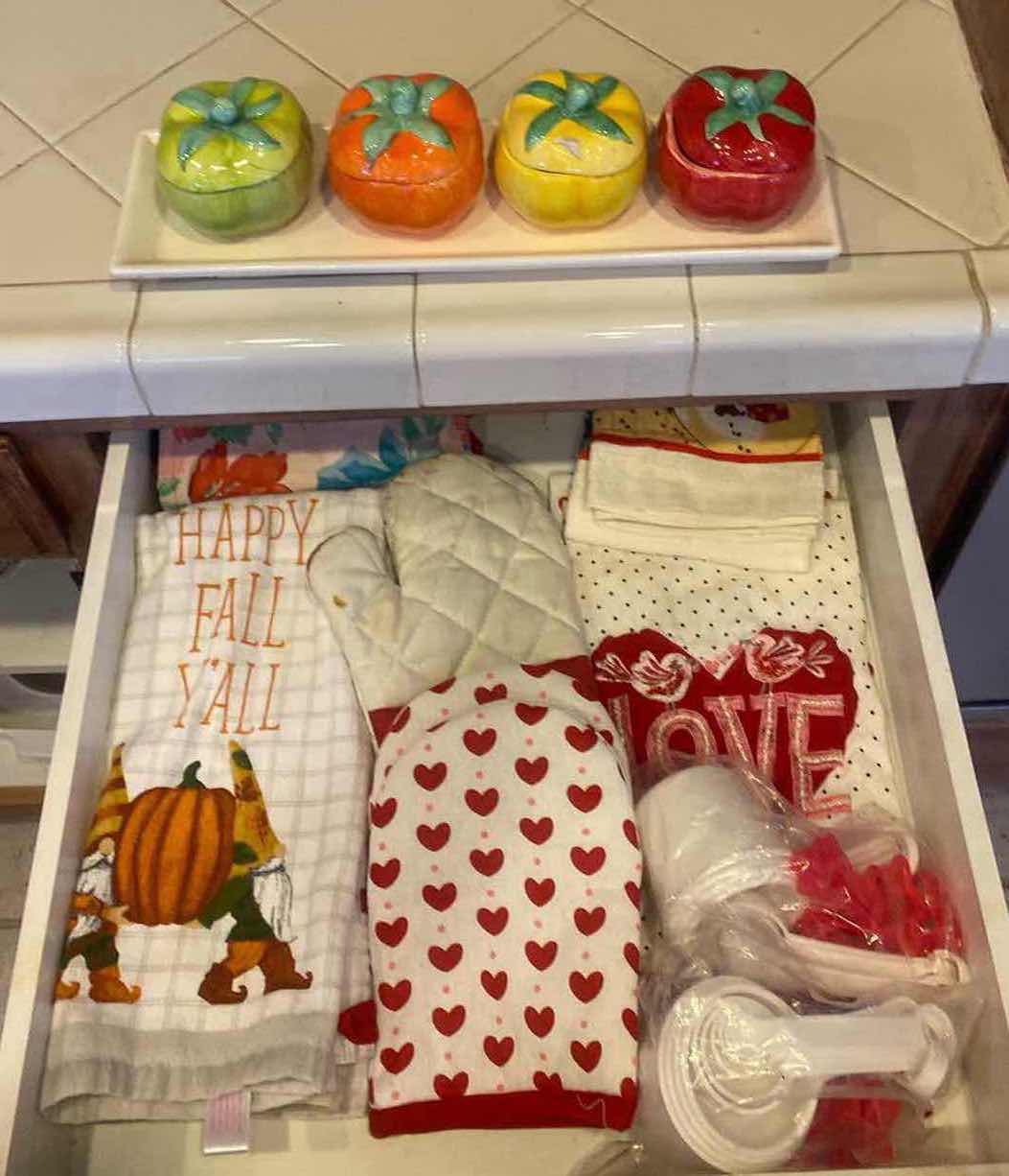 Photo 1 of CONTENTS KITCHEN CABINET -  POT HOLDERS TOWELS & 5 PIECE CERAMIC PEPPER SET