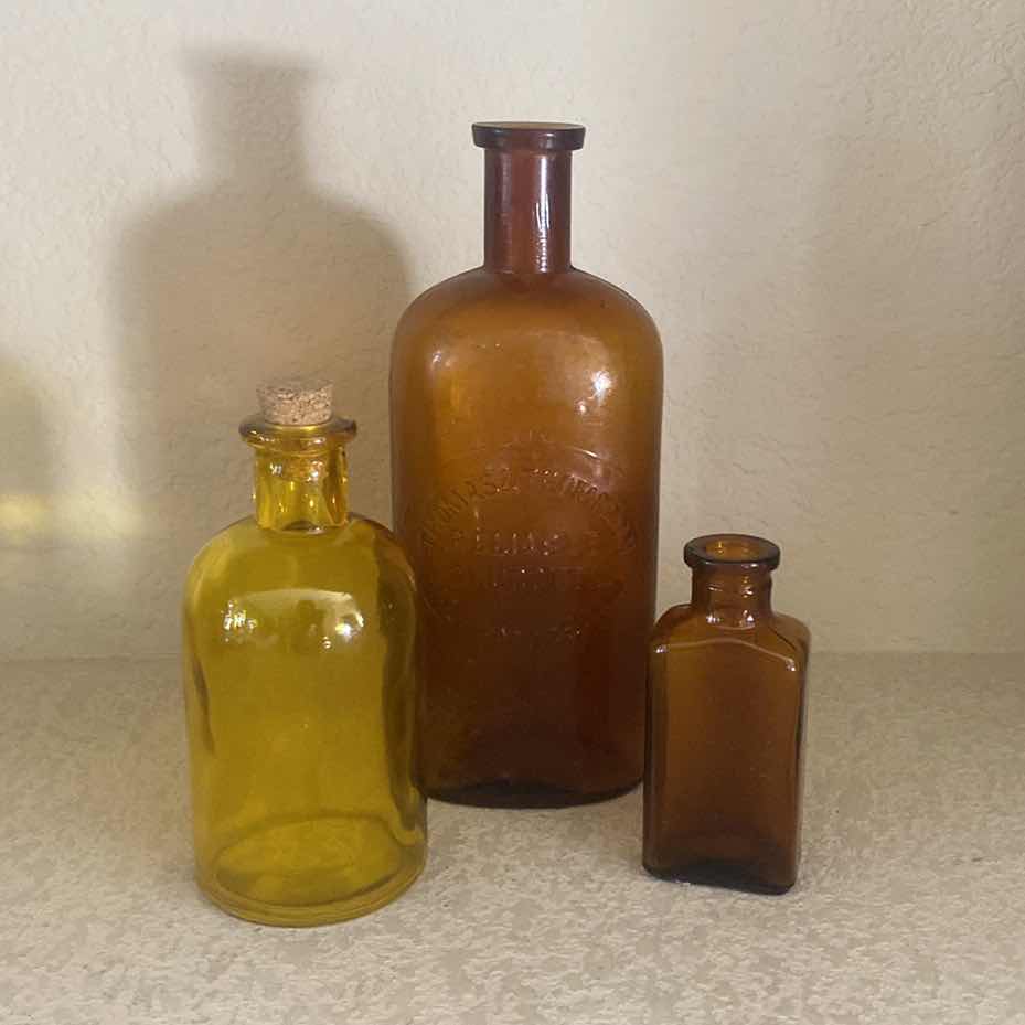 Photo 1 of THOMAS & THOMPSON AMBER GLASS 16oz DRUG STORE BOTTLE WITH 3 SMALL BOTTLED UNMARKED
