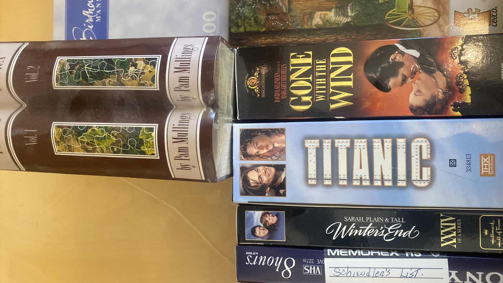 Photo 1 of CONTENTS OF DRAWER, VHS MOVIES, PUZZLES, AND FAUX BOOK DECOR