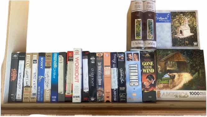 Photo 1 of CONTENTS OF DRAWER, VHS MOVIES, PUZZLES, AND FAUX BOOK DECOR