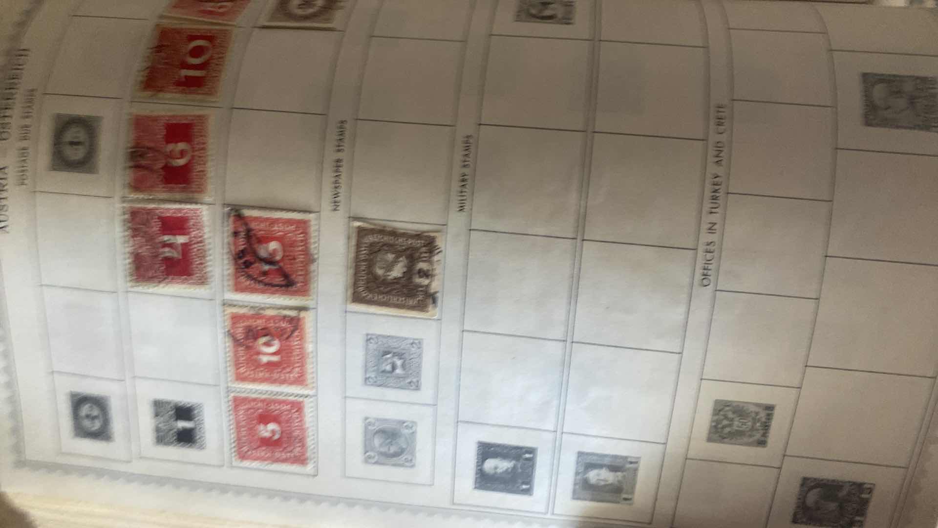 Photo 1 of THE COMPREHENSIVE WORLDWIDE STAMP ALBUM WITH ASSORTMENT OF STAMPS