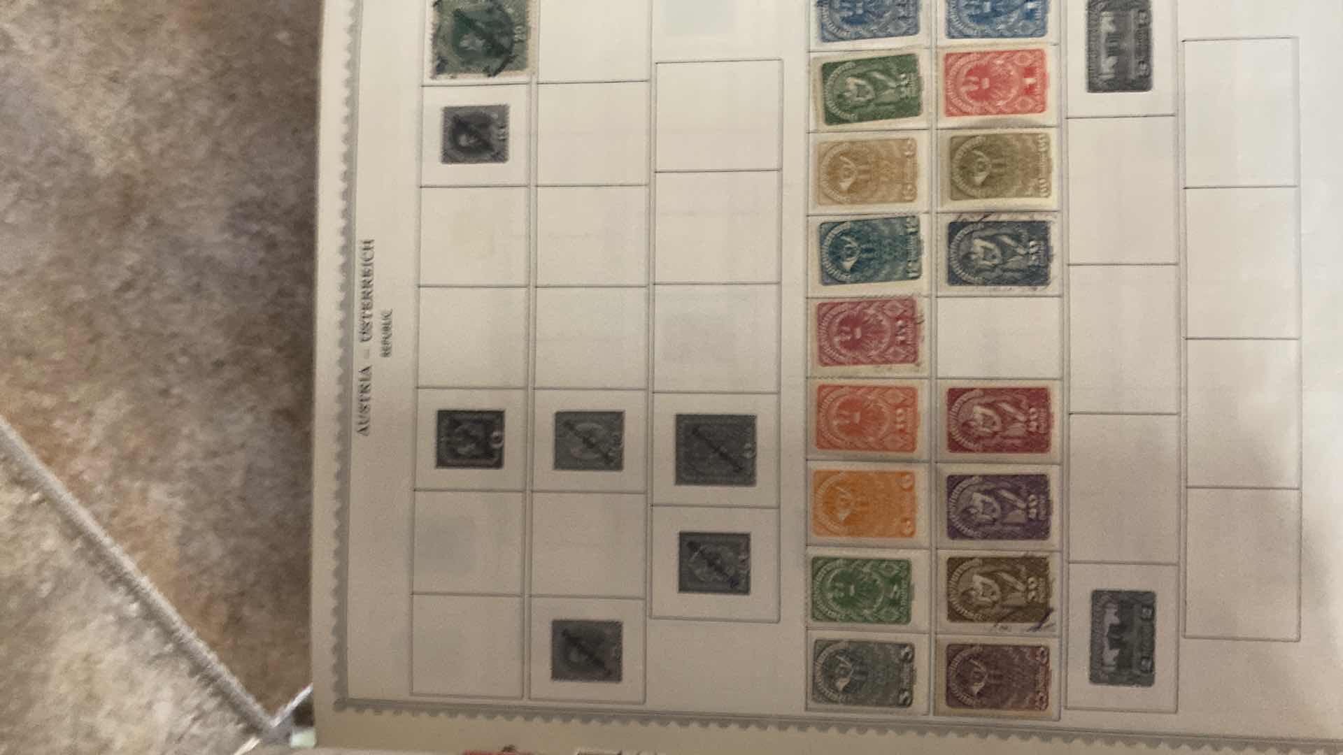 Photo 1 of THE COMPREHENSIVE WORLDWIDE STAMP ALBUM WITH ASSORTMENT OF STAMPS