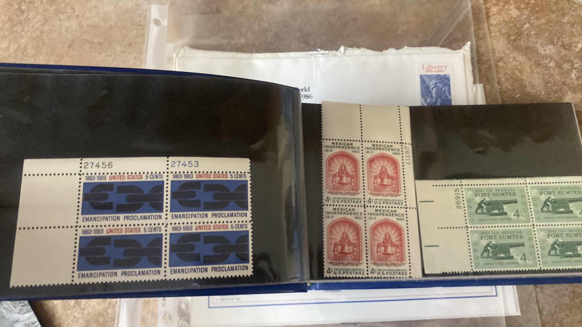 Photo 1 of STAMP COLLECTION ALBUM AND TWO OFFICIAL CENTENNIAL SEAL STATUE OF LIBERTY RESTORATION