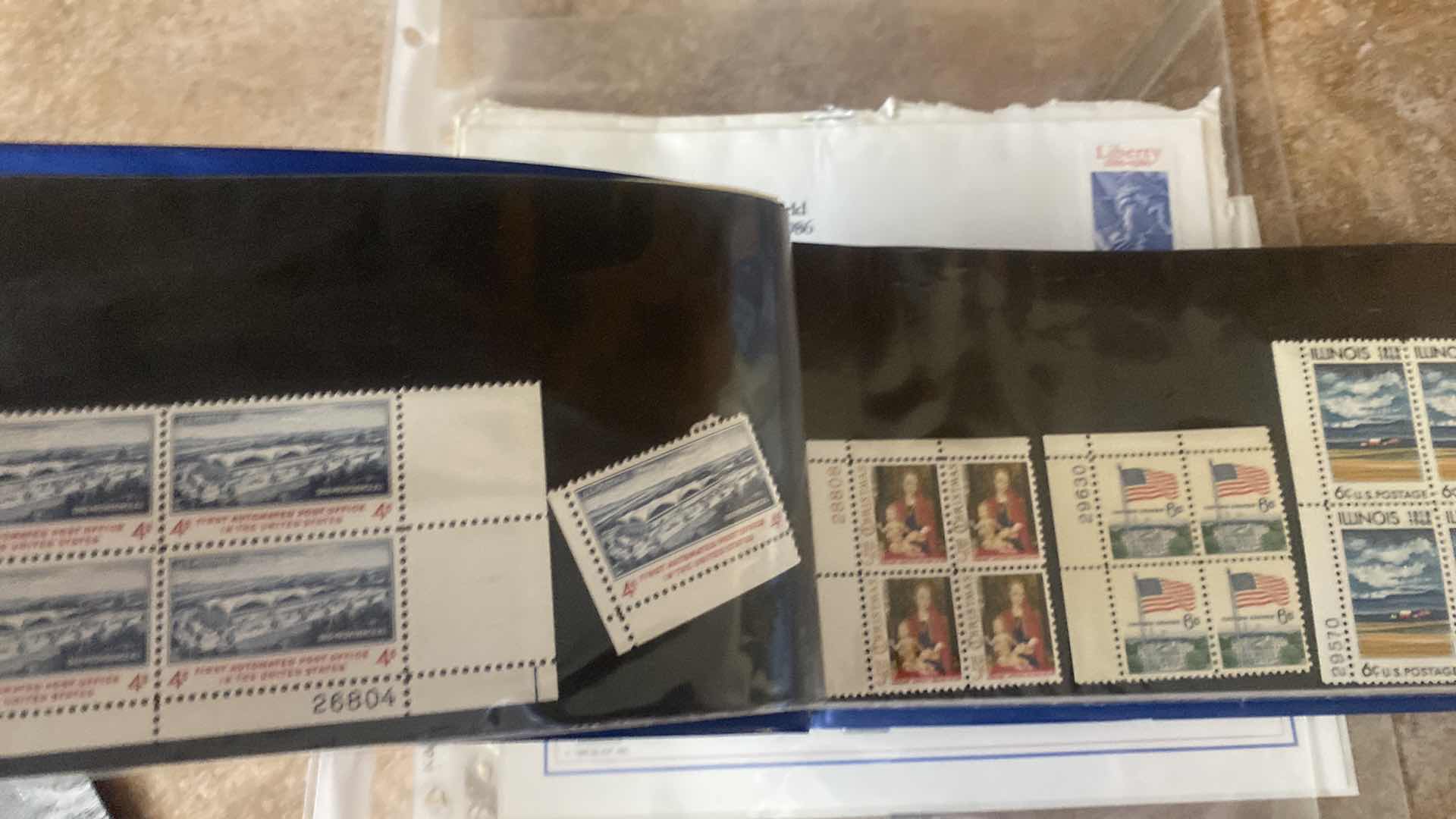 Photo 1 of STAMP COLLECTION ALBUM AND TWO OFFICIAL CENTENNIAL SEAL STATUE OF LIBERTY RESTORATION