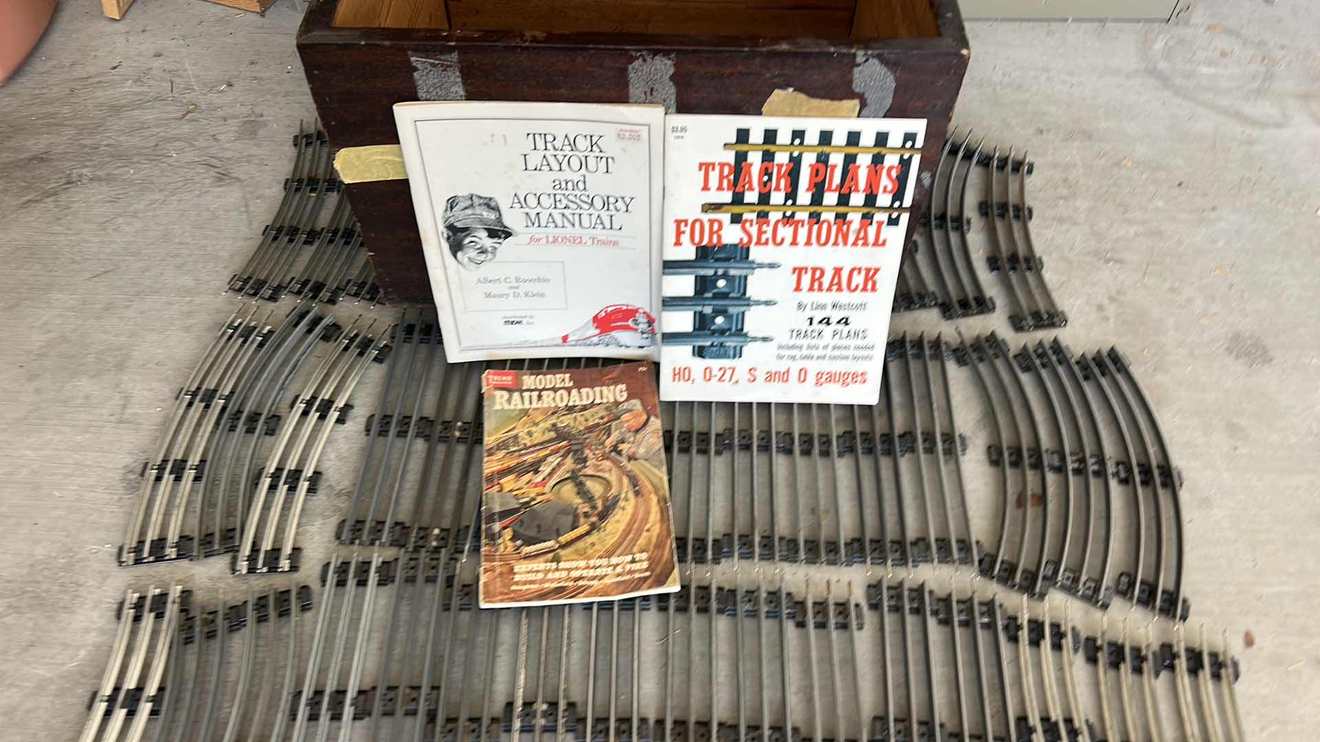Photo 1 of LIONEL TRAIN TRACKS & MORE - 32 STRAIGHT, 22 CURVED, CONTROL SWITCHES, LAYOUT GUIDE, VINTAGE MODEL RAILROAD MAGAZINE & MANUALS WITH VINTAGE TRUNK