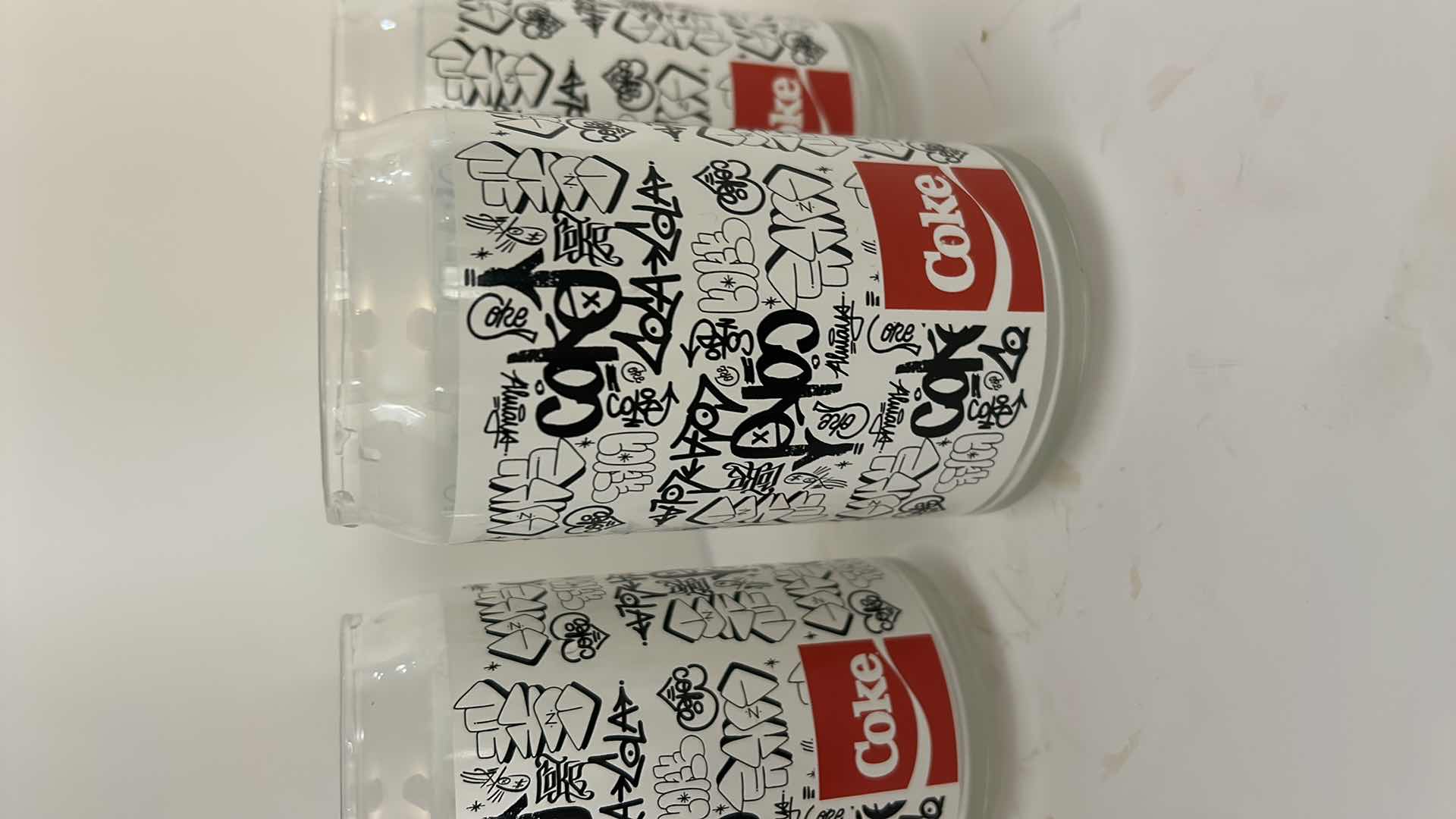 Photo 1 of COCA-COLA 7 PIECE GLASSWARE SET WITH BLACK & WHITE GRAPHIC DESIGN- COLLECTIBLE COKE DRINKING GLASES ESTIMATED RETAIL VALUE:$50