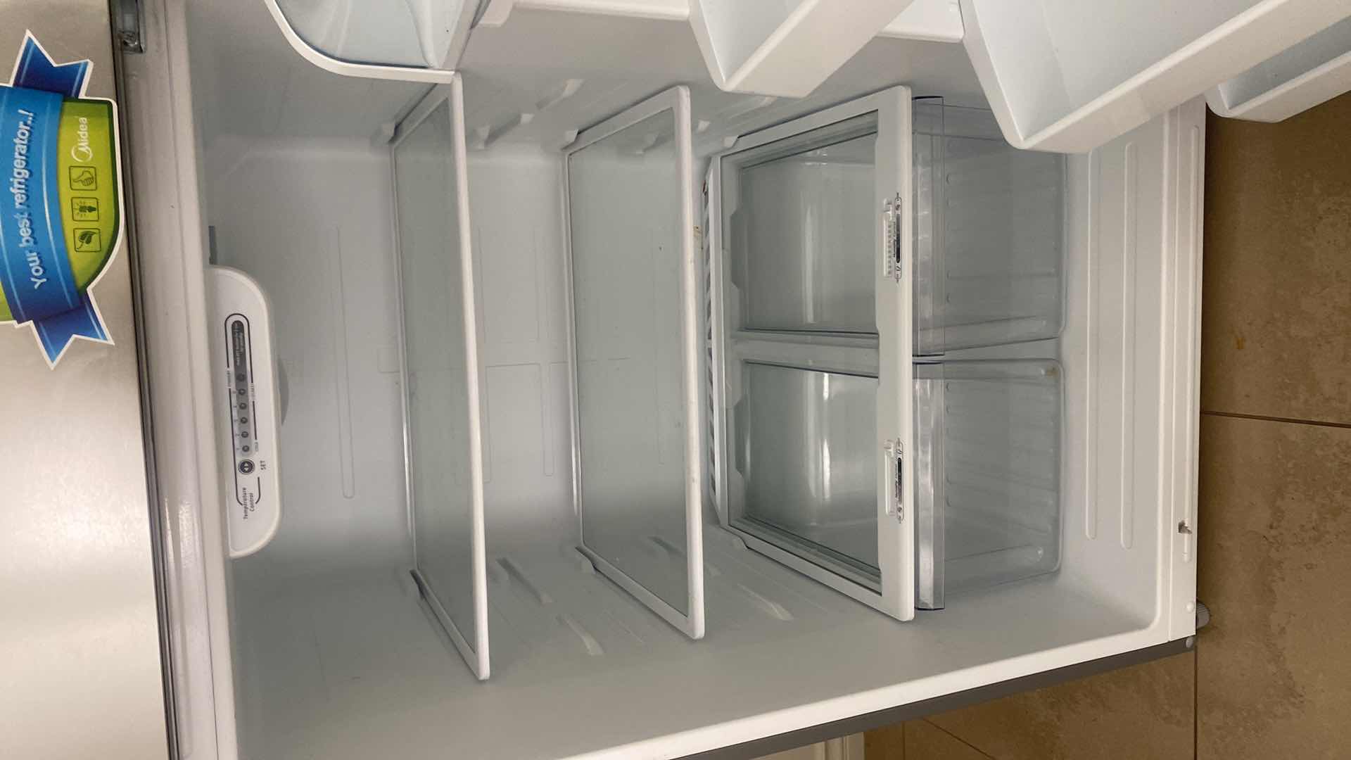 Photo 1 of MIDEA STAINLESS STEEL TOP FREEZER REFRIGERATOR, REVERSIBLE DOORS 29 1/2” X 32” H 66 1/2”