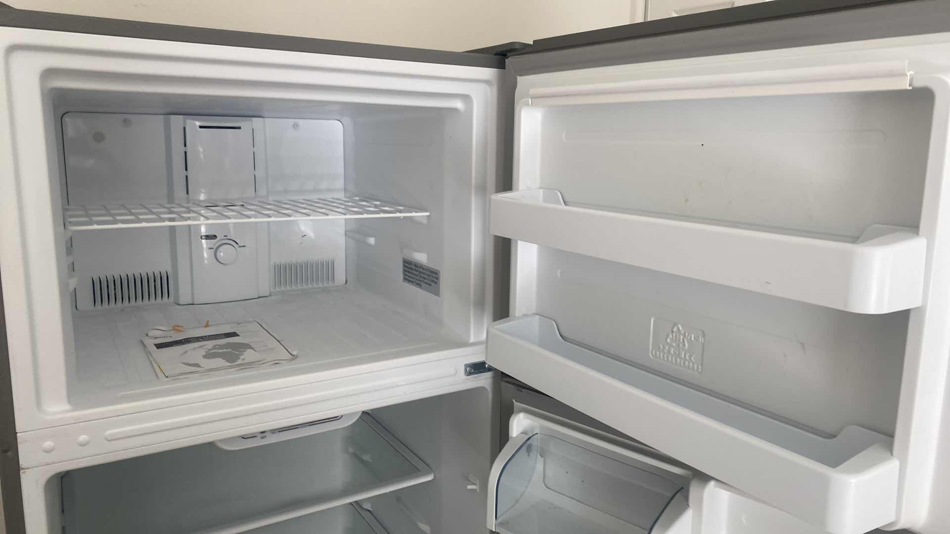 Photo 1 of MIDEA STAINLESS STEEL TOP FREEZER REFRIGERATOR, REVERSIBLE DOORS 29 1/2” X 32” H 66 1/2”