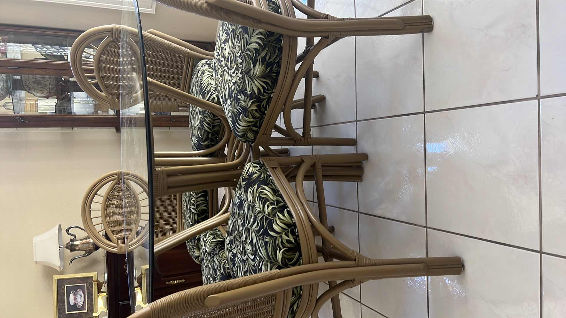 Photo 1 of 48” ROUND GLASSTOP CANE BASE TABLE  W 5 SIDE CHAIRS COVERED IN BLACK & GREEN LEAF UPHOLSTERY (H30")