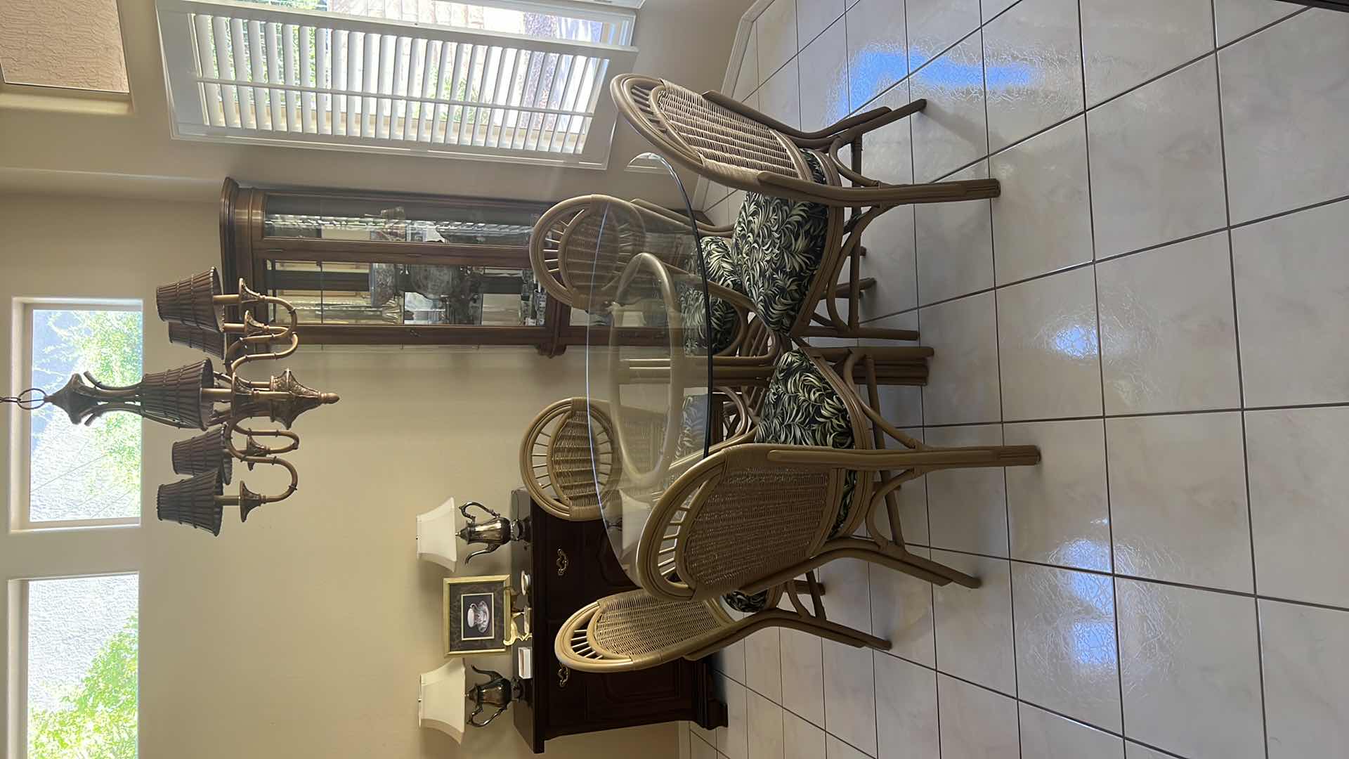 Photo 1 of 48” ROUND GLASSTOP CANE BASE TABLE  W 5 SIDE CHAIRS COVERED IN BLACK & GREEN LEAF UPHOLSTERY (H30")