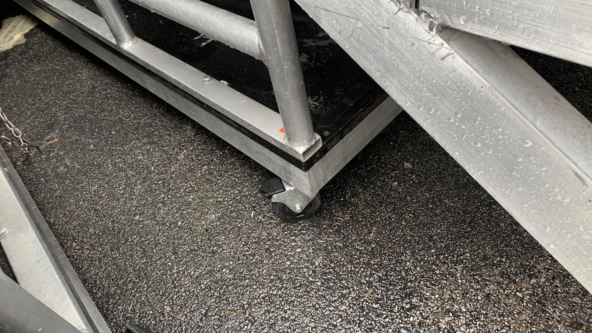 Photo 1 of ONE LARGE HEAVY DUTY ELEVEN STEP METAL AND PEXI-GLASS STAGE STAIRS WITH WHEELS 4’ X 12’ H 7’4” 