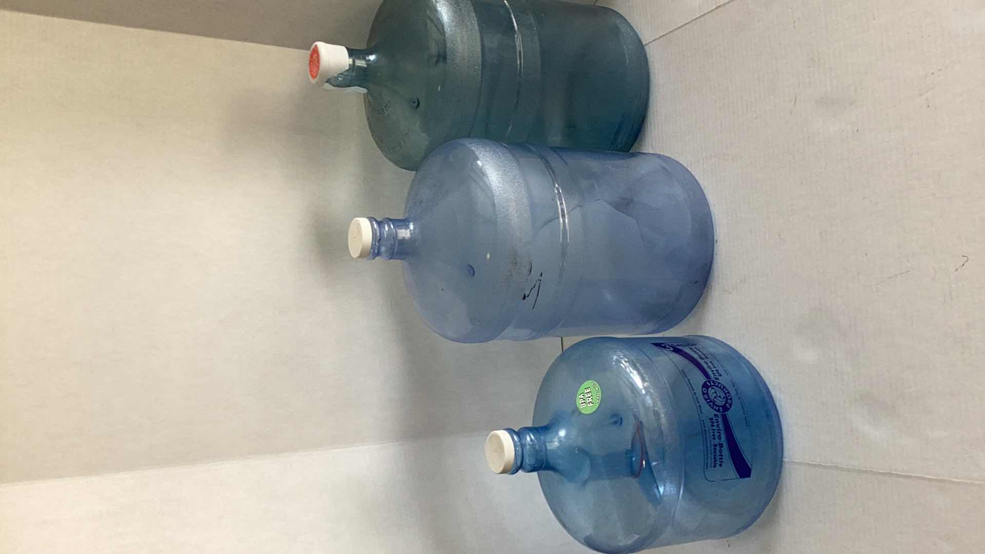 Photo 1 of THREE PLASTIC WATER BOTTLES