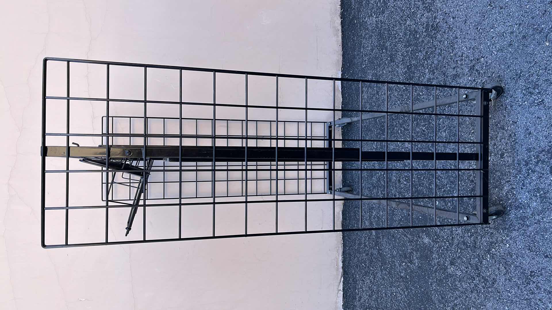 Photo 1 of DOUBLE SIDE MERCHANDISE RACK ON WHEELS 18” X 50.25” H56.5”, BLACK (1)