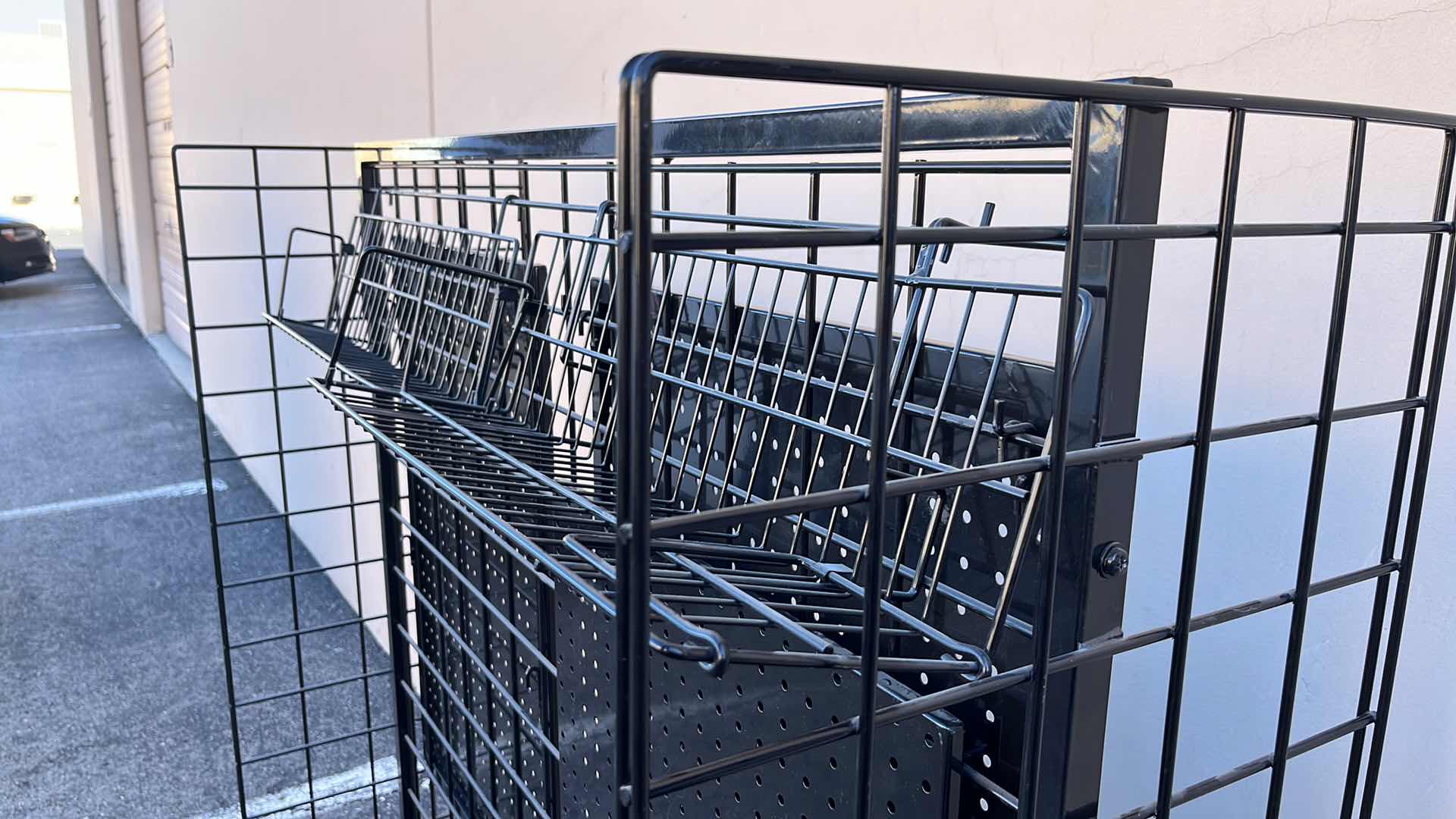 Photo 1 of DOUBLE SIDE MERCHANDISE RACK ON WHEELS 18” X 50.25” H56.5”, BLACK (1)